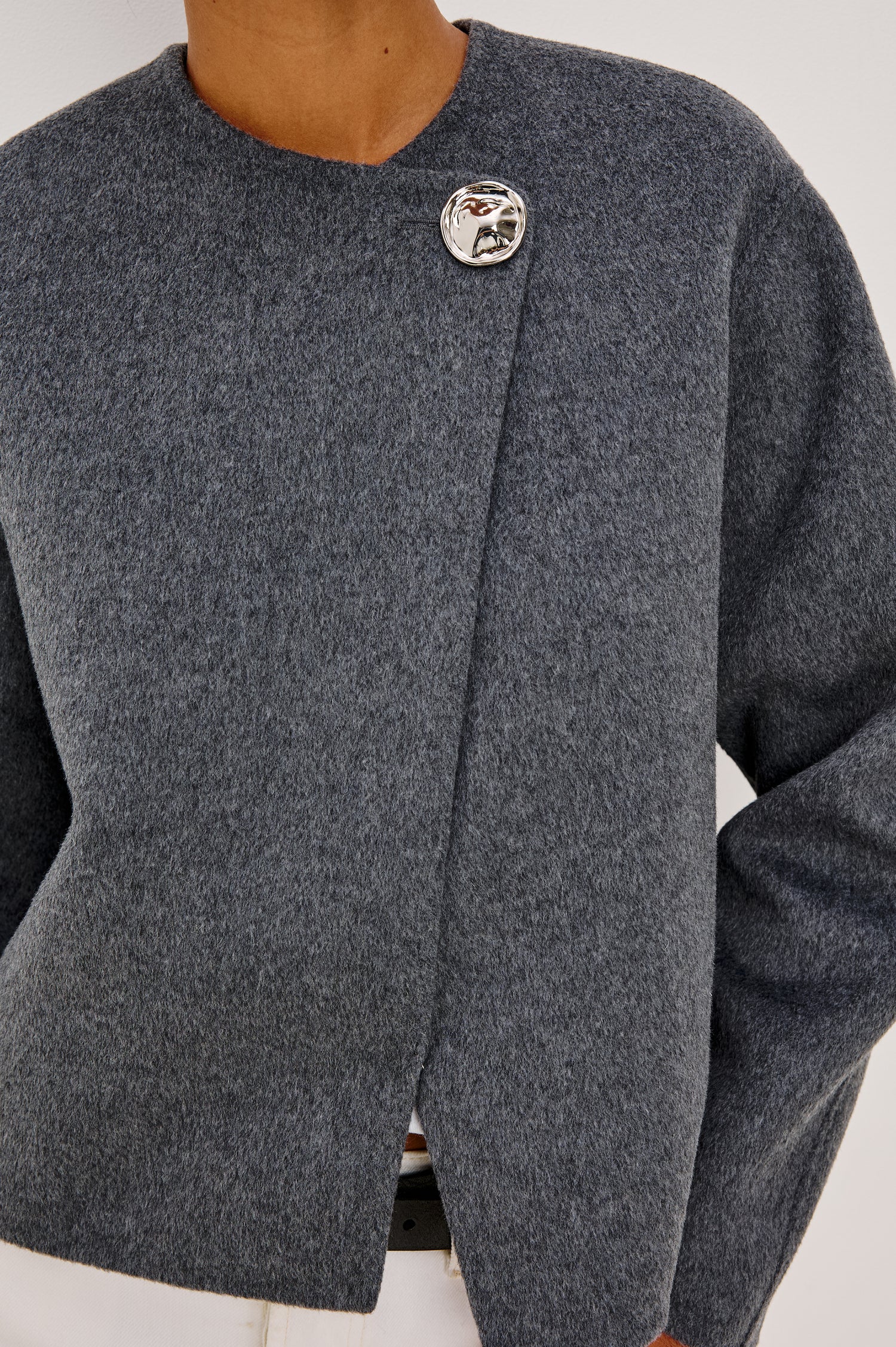 Ronda Jacket in Heavy Wool Blend With Boxy Wrap Style Design, Front Molded Metallic Button Closure, Long Sleeves, and is Unlined in Heater Charcoal Colorway - Upper Body Close Up Front View Featured on Model
