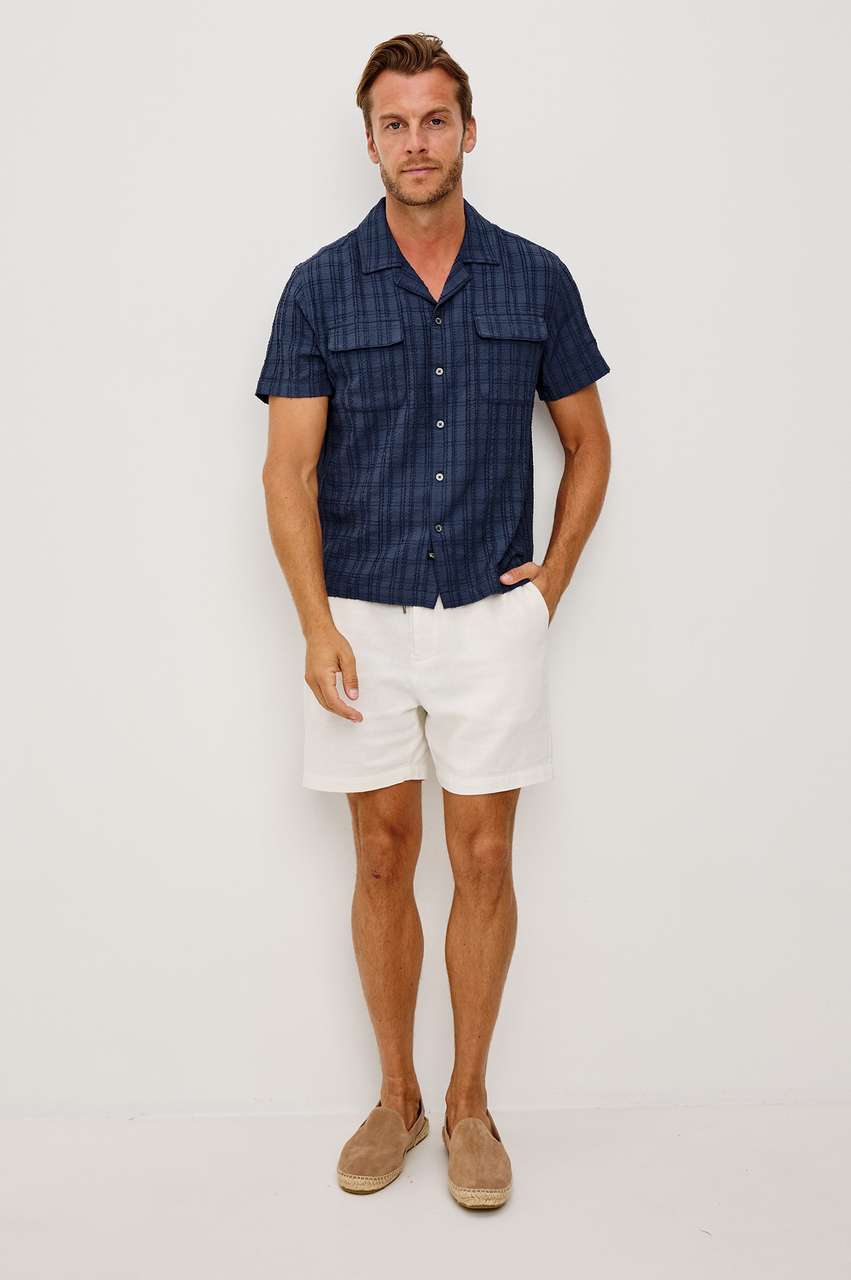 Rook Button-Up Shirt With Crosshatch Texture, Notched Collar, Short Sleeves, and Slightly Boxy Fit in Navy Colorway - Full Body Front View Featured on Model