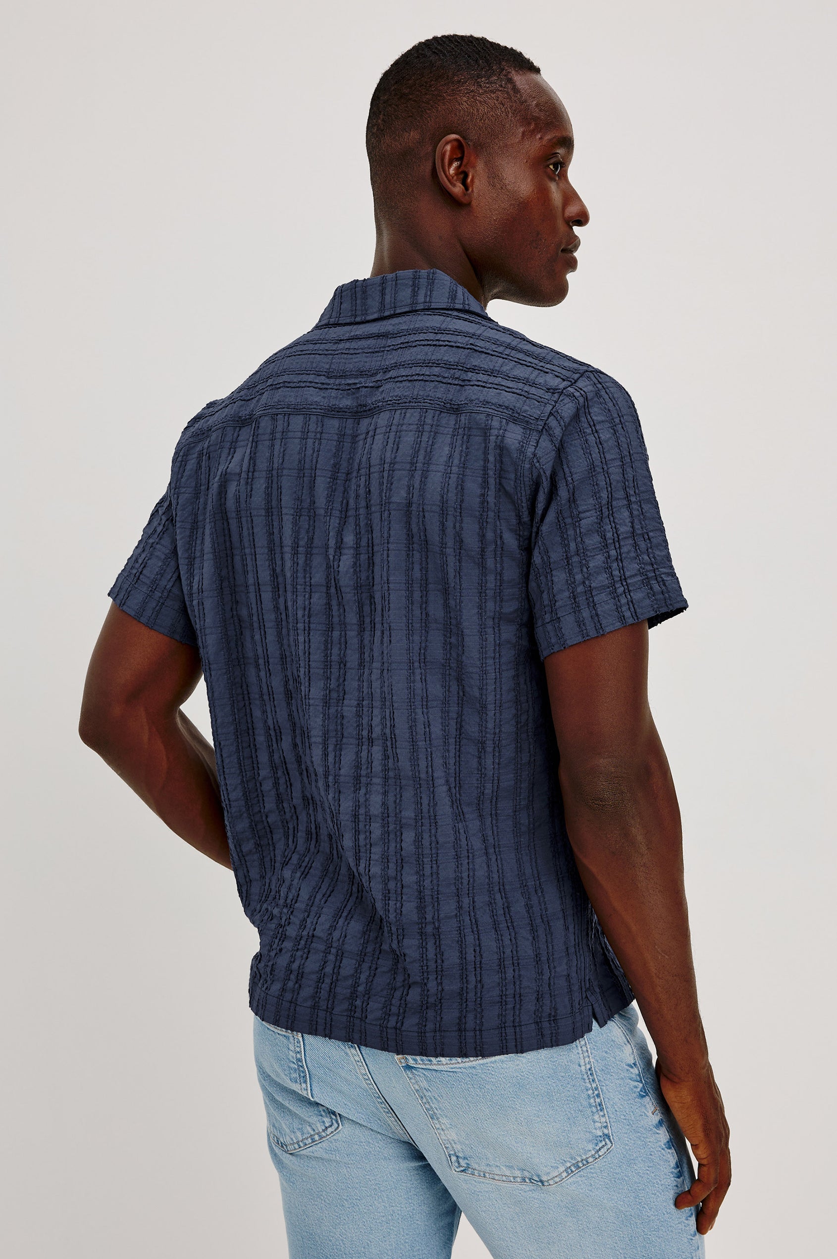 Rook Button-Up Shirt With Crosshatch Texture, Notched Collar, Short Sleeves, and Slightly Boxy Fit in Navy Colorway - Upper Body Front View Featured on Model