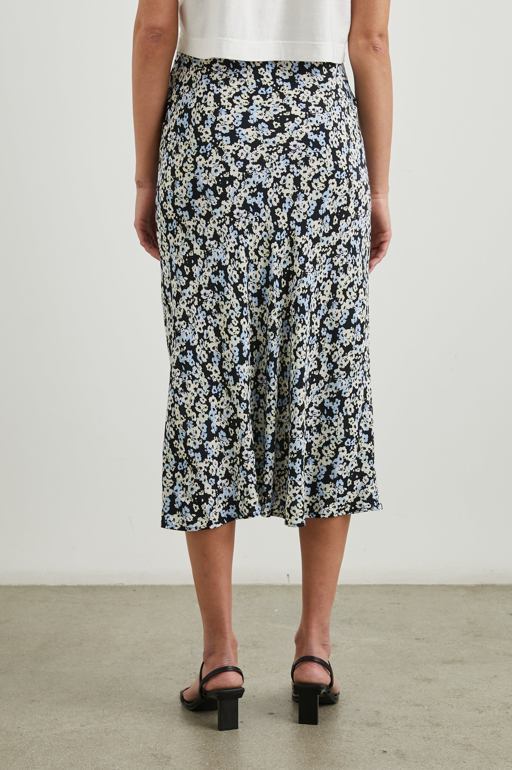Rosetta Midi Skirt with Buttons Down the Front in Midnight Meadow Floral Colorway, blue and white flowers on Midnight - Back View Featured on Model 