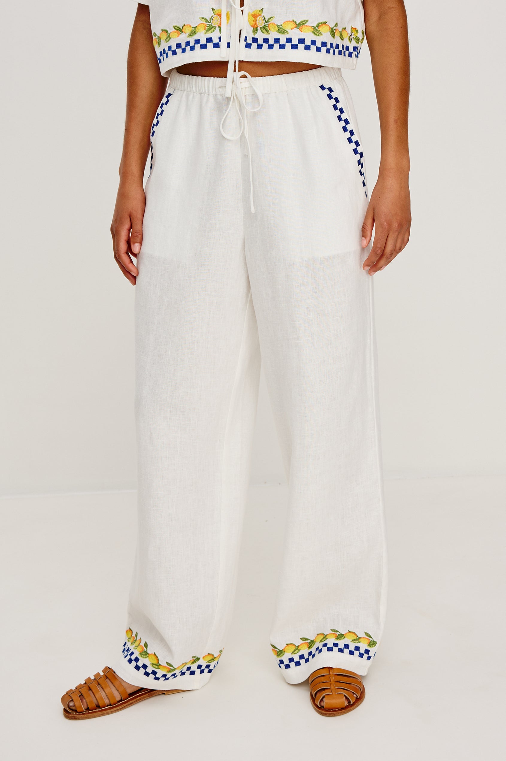 Rosita linen pant in Sorrento Embroidery colorway featuring side pockets, drawstring waist, and Italian inspired embroidery - front view on model
