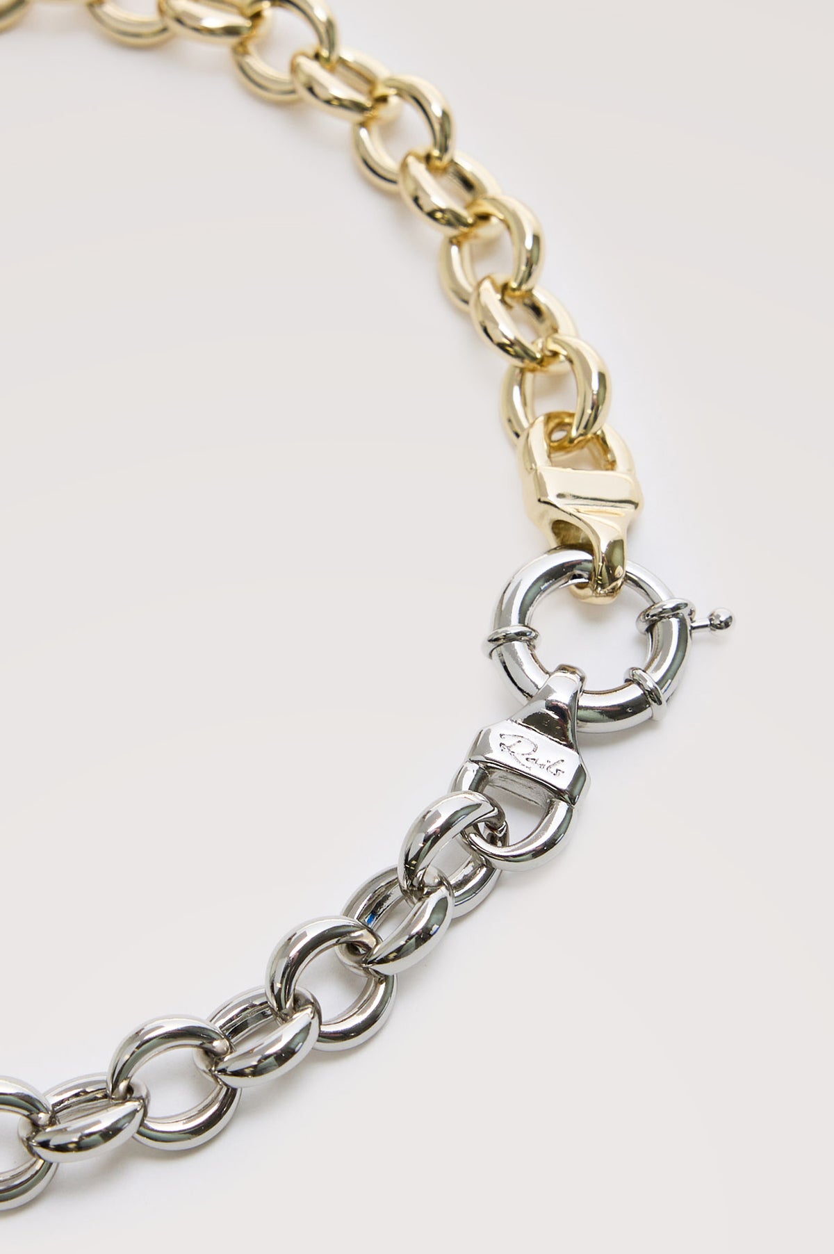 Round Link Chain Necklace With Chunky Round Links With Mixed-Metal Design, Toggle Closure, and Engraved Rails Logo at Interior in Silver Gold Colorway - Close up view featured of clasp.