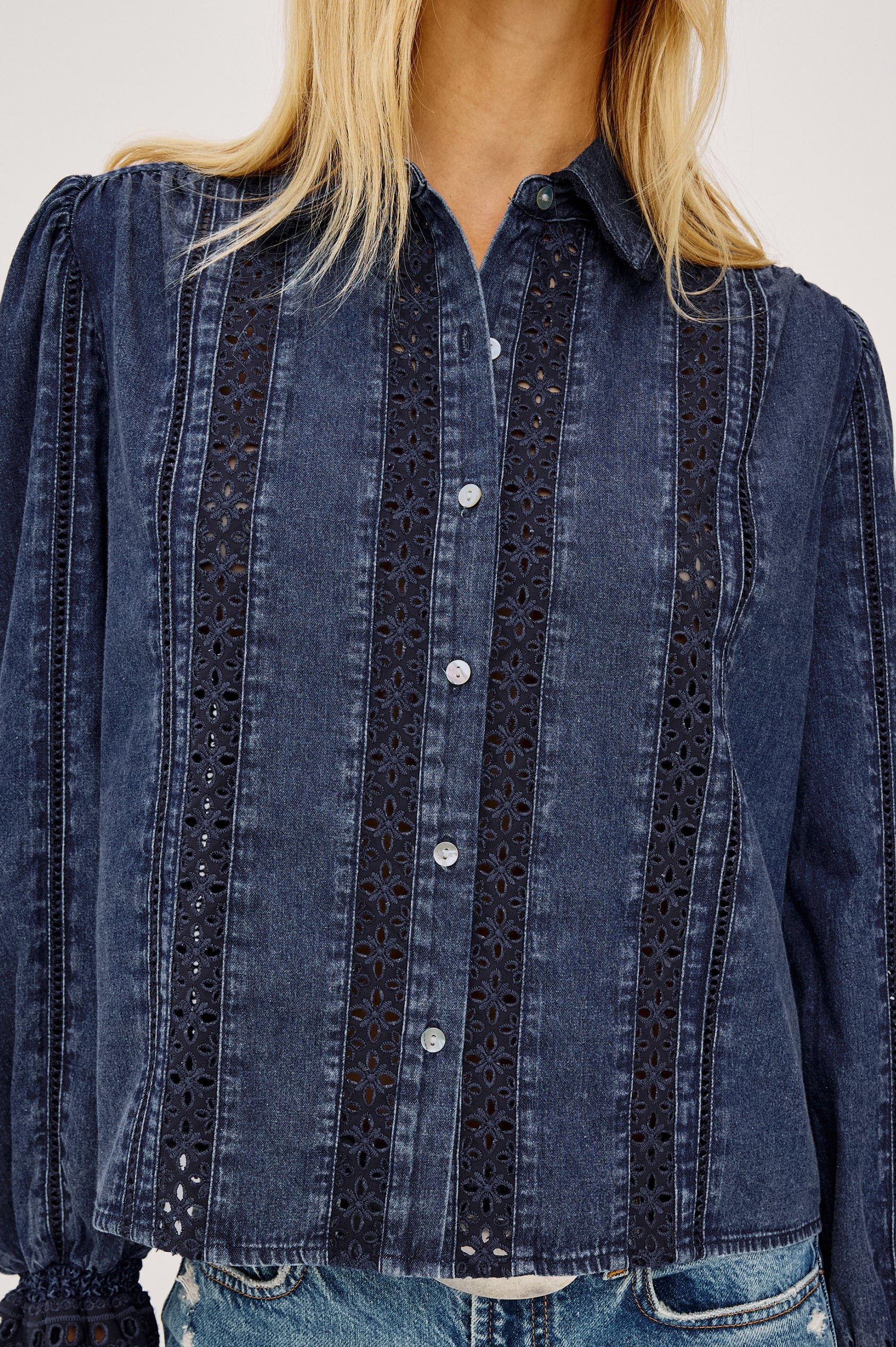 Rowen Shirt in Cotton Chambray With Cropped, Boxy Fit, Front Buttons, Long Puff Sleeves, Contrast Semi-Sheer Eyelet Panels, and Embroidered Trim at Collar and Flared Cuffs in Classic Blue Colorway - Upper Body Front View Featured on Model