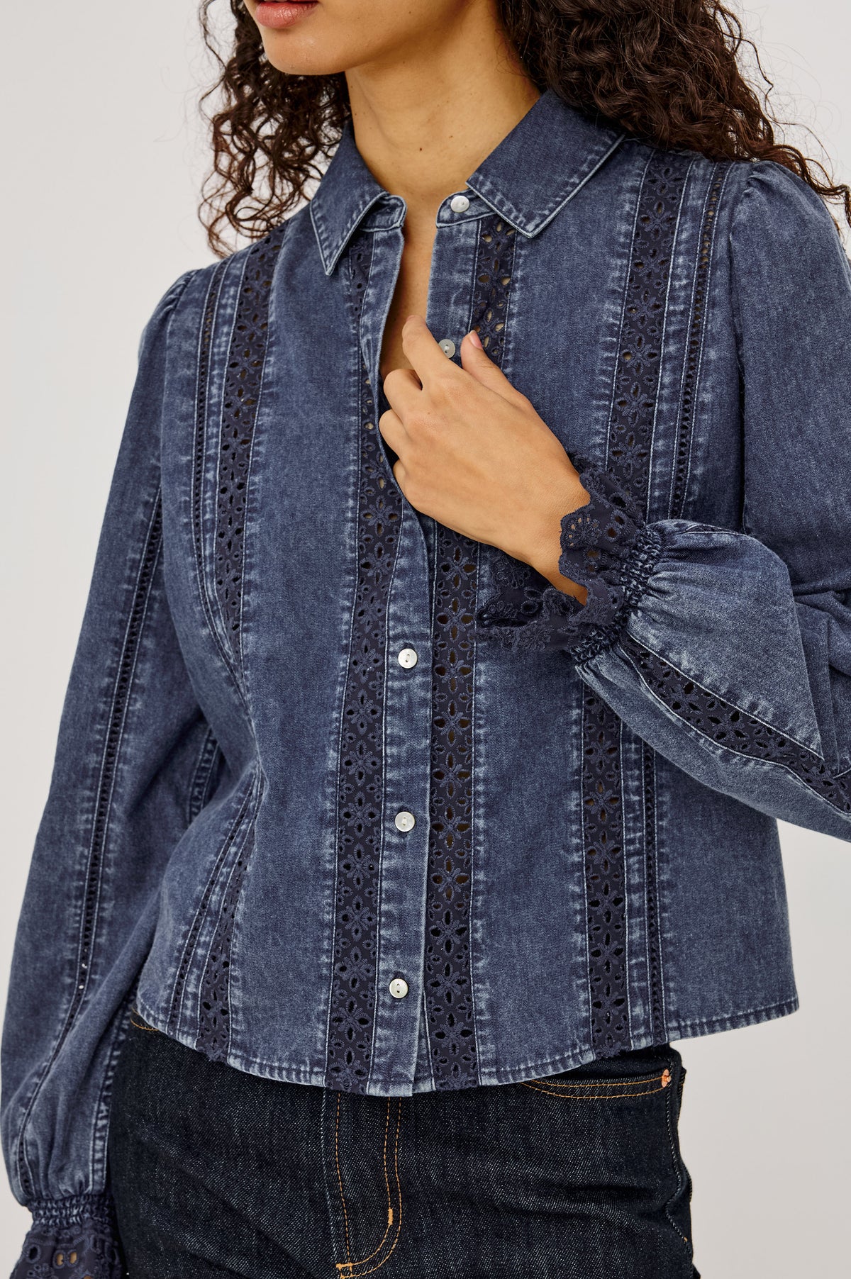 Rowen Shirt in Cotton Chambray With Cropped, Boxy Fit, Front Buttons, Long Puff Sleeves, Contrast Semi-Sheer Eyelet Panels, and Embroidered Trim at Collar and Flared Cuffs in Classic Blue Colorway - Upper Body Front View Featured on Model