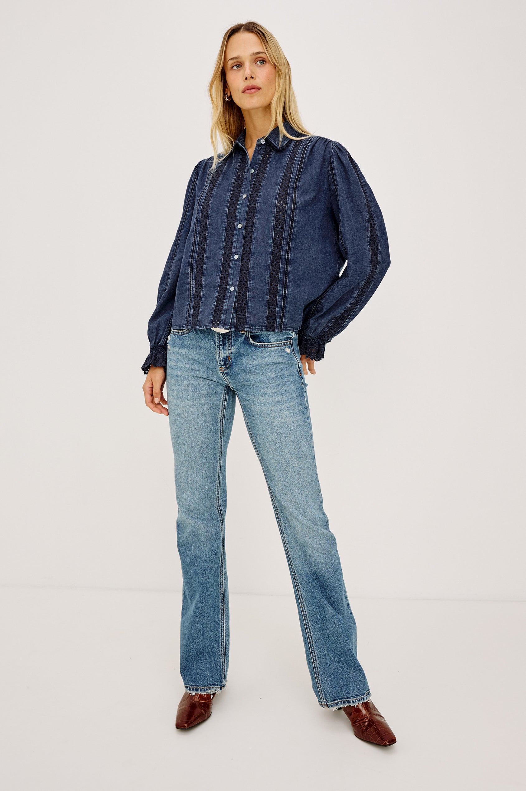 Rowen Shirt in Cotton Chambray With Cropped, Boxy Fit, Front Buttons, Long Puff Sleeves, Contrast Semi-Sheer Eyelet Panels, and Embroidered Trim at Collar and Flared Cuffs in Classic Blue Colorway - Full Body Front View Featured on Model