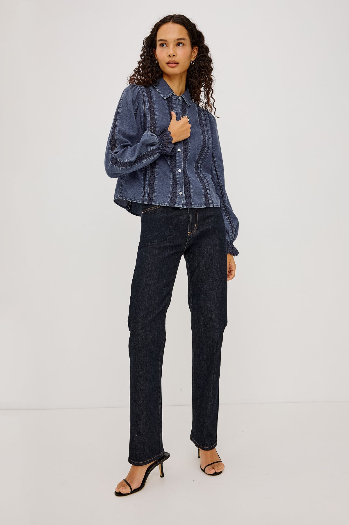 Rowen Shirt in Cotton Chambray With Cropped, Boxy Fit, Front Buttons, Long Puff Sleeves, Contrast Semi-Sheer Eyelet Panels, and Embroidered Trim at Collar and Flared Cuffs in Classic Blue Colorway - Full Body Front View Featured on Model