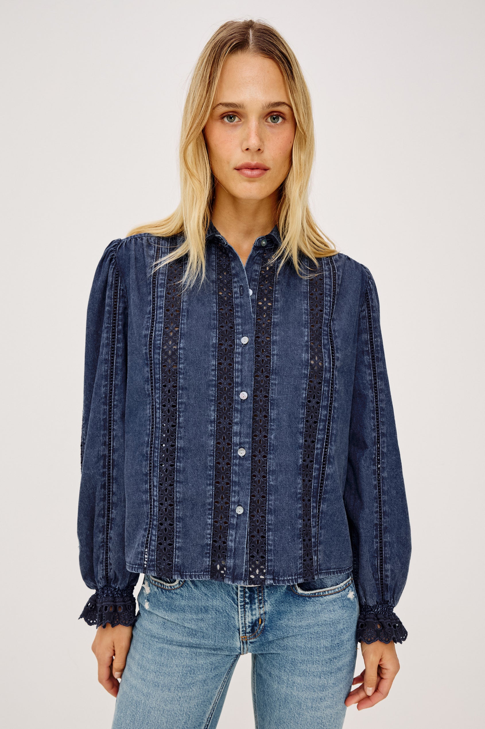 Rowen Shirt in Cotton Chambray With Cropped, Boxy Fit, Front Buttons, Long Puff Sleeves, Contrast Semi-Sheer Eyelet Panels, and Embroidered Trim at Collar and Flared Cuffs in Classic Blue Colorway - Upper Body Front View Featured on Model