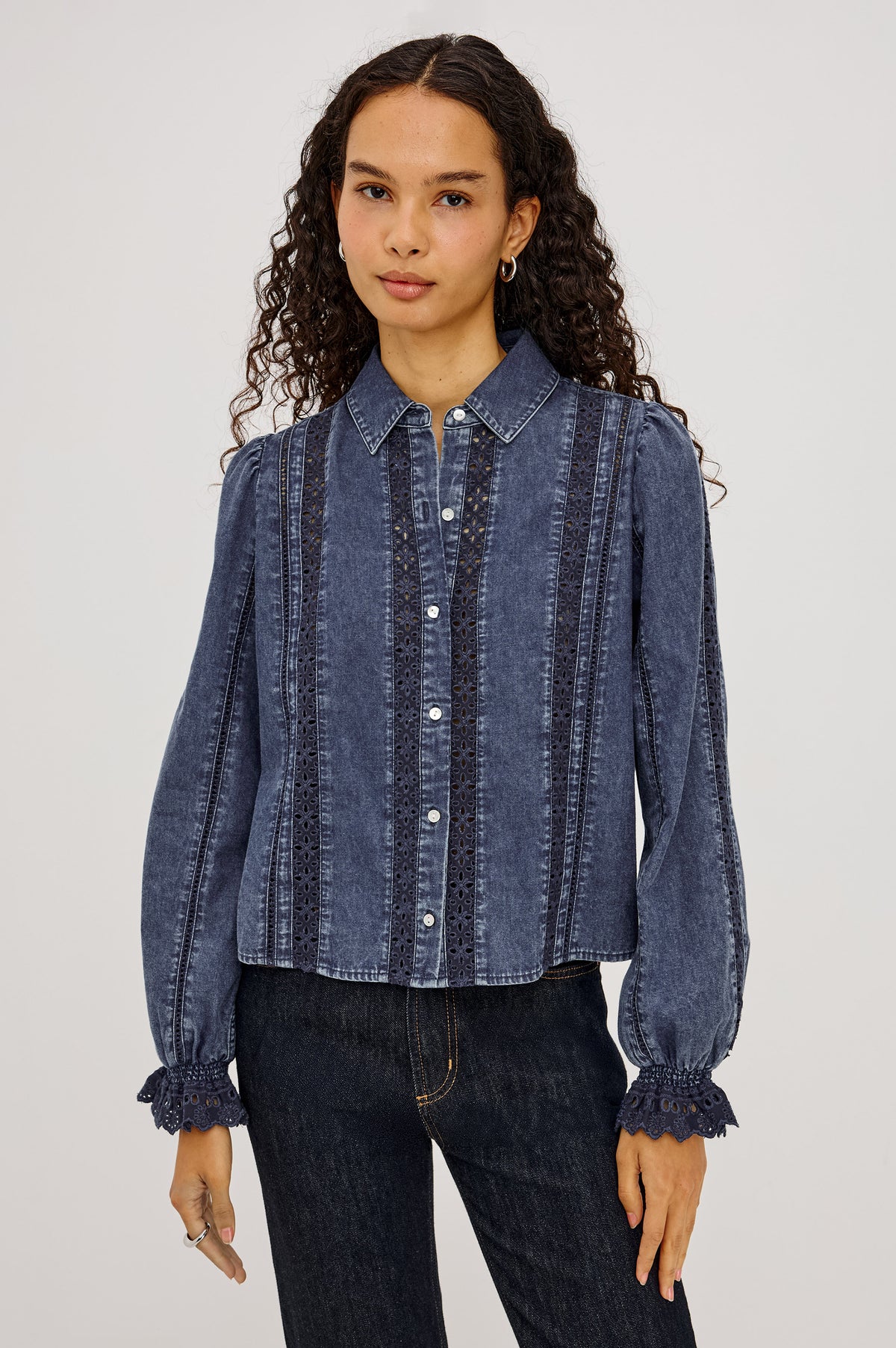 Rowen Shirt in Cotton Chambray With Cropped, Boxy Fit, Front Buttons, Long Puff Sleeves, Contrast Semi-Sheer Eyelet Panels, and Embroidered Trim at Collar and Flared Cuffs in Classic Blue Colorway - Upper Body Front View Featured on Model