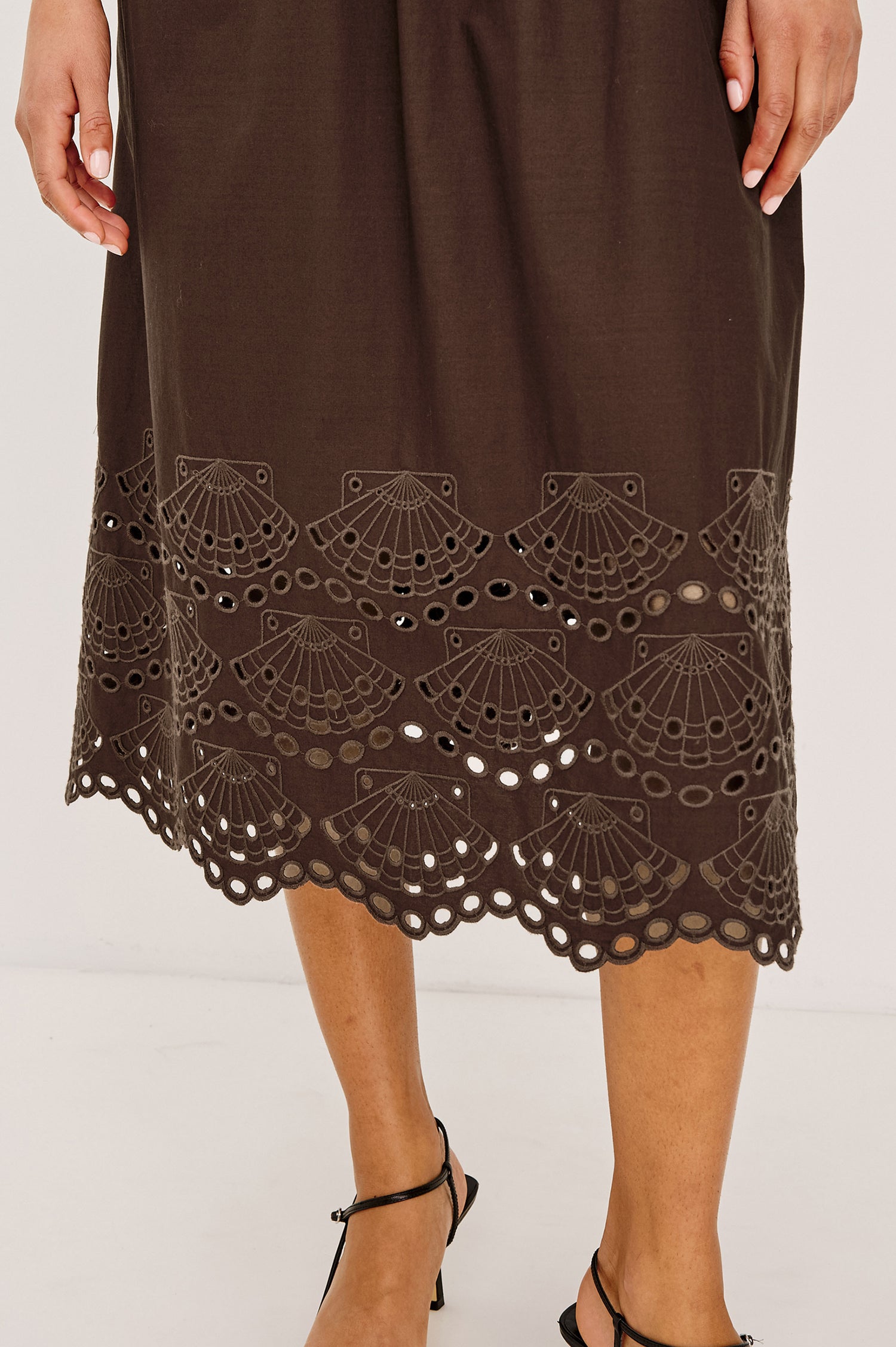 Roxanne Midi Dress in Cotton Poplin With Shirred Shoulders, Plunging V-Neck, Smocked Waist and Seashell Hem Embroidery in Espresso Colorway - Lower Body Close Up View Featured on Model