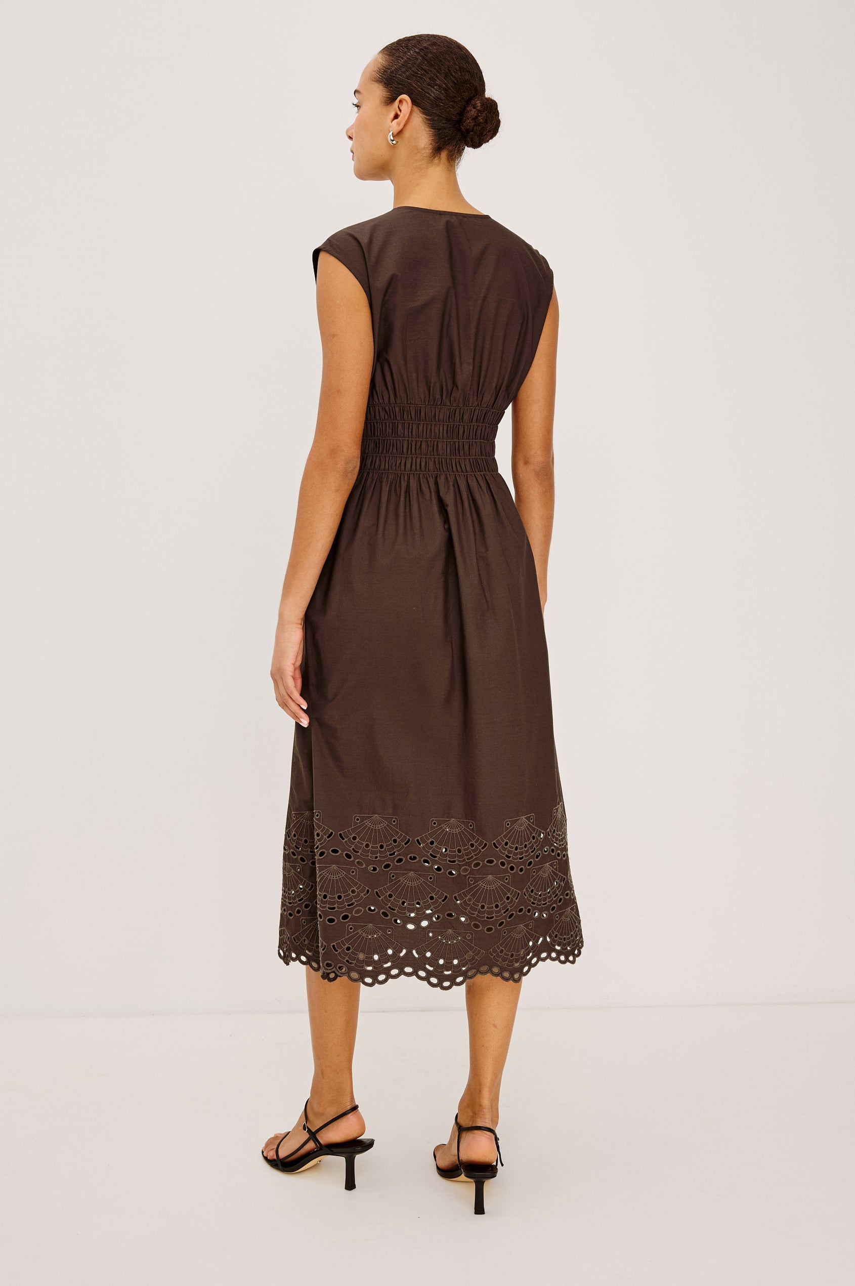 Roxanne Midi Dress in Cotton Poplin With Shirred Shoulders, Plunging V-Neck, Smocked Waist and Seashell Hem Embroidery in Espresso Colorway - Full Body Back View Featured on Model