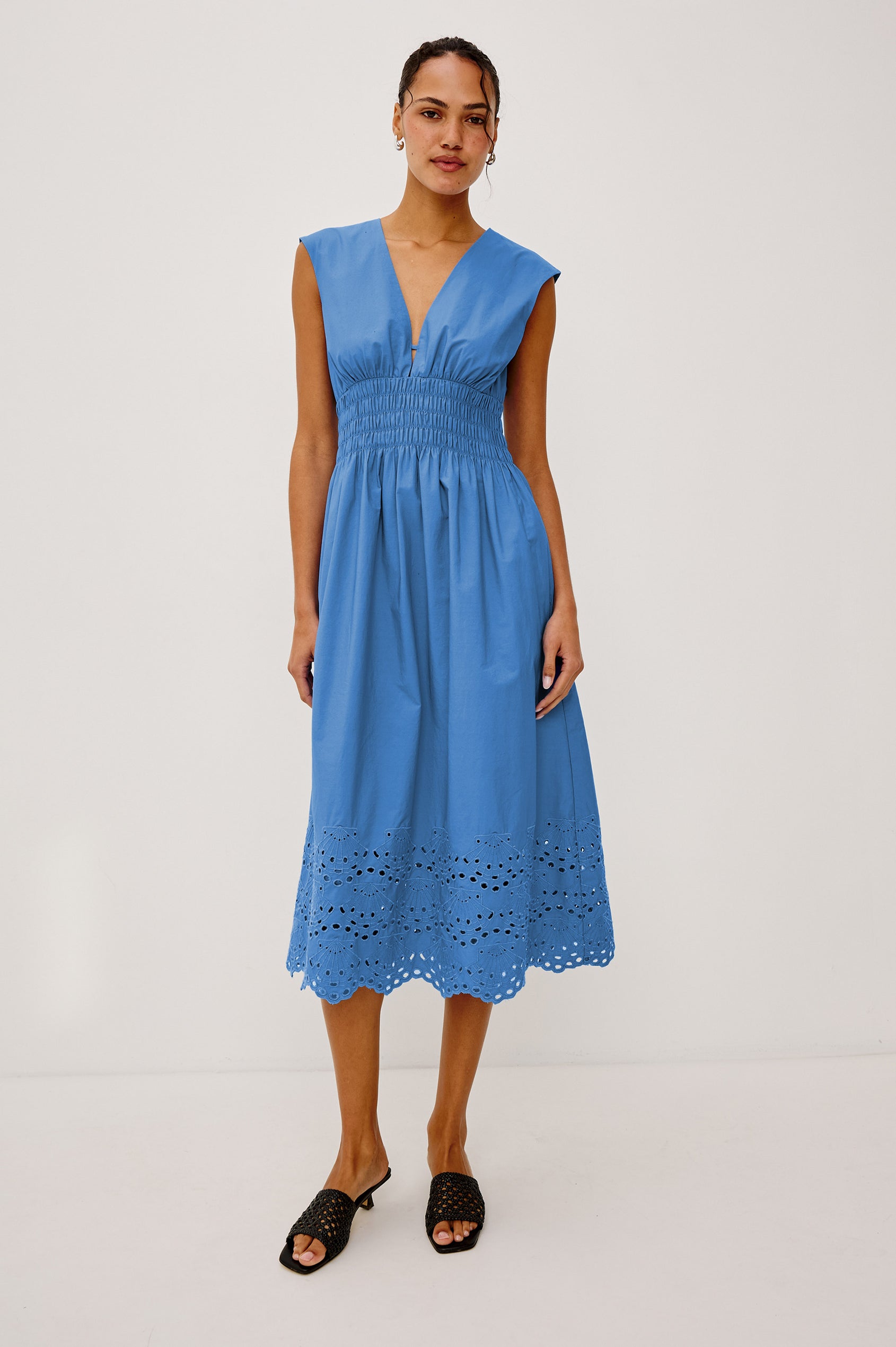 Roxanne Midi Dress in Cotton Poplin With Shirred Shoulders, Plunging V-Neck, Smocked Waist and Seashell Hem Embroidery in Harbor Blue Colorway - Full Body Front View Featured on Model
