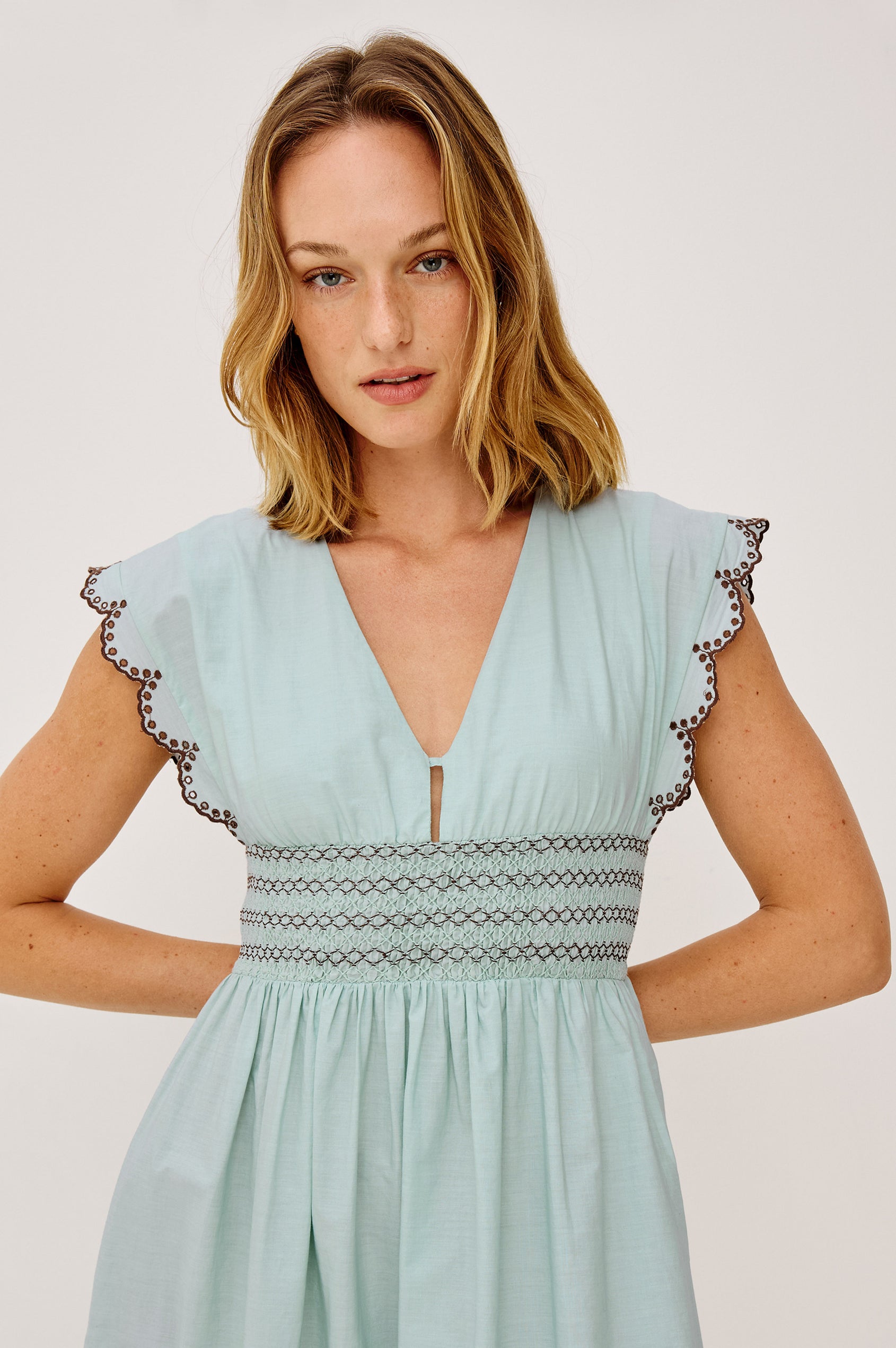 Roxanne Midi Dress in Cotton Poplin With Shirred Shoulders, Plunging V-Neck, and Smocked Waist in Ocean Palms Embroidery - Upper Body Front View Featured on Model