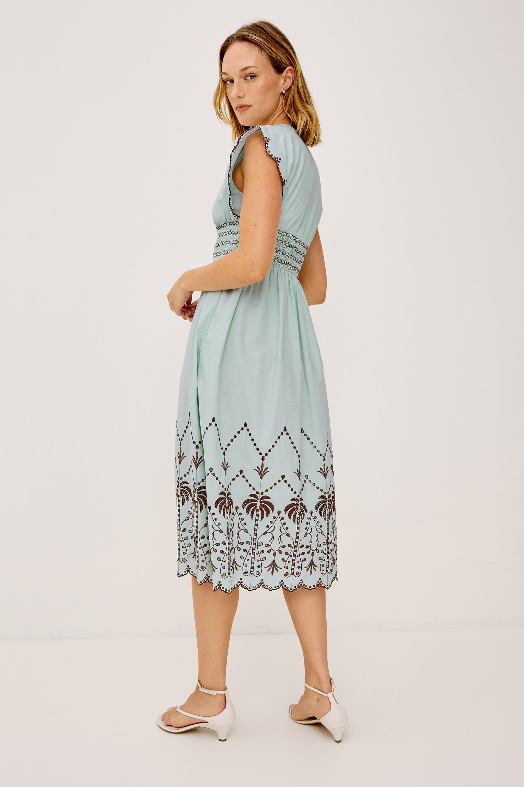 Roxanne Midi Dress in Cotton Poplin With Shirred Shoulders, Plunging V-Neck, and Smocked Waist in Ocean Palms Embroidery - Full Body Back View Featured on Model