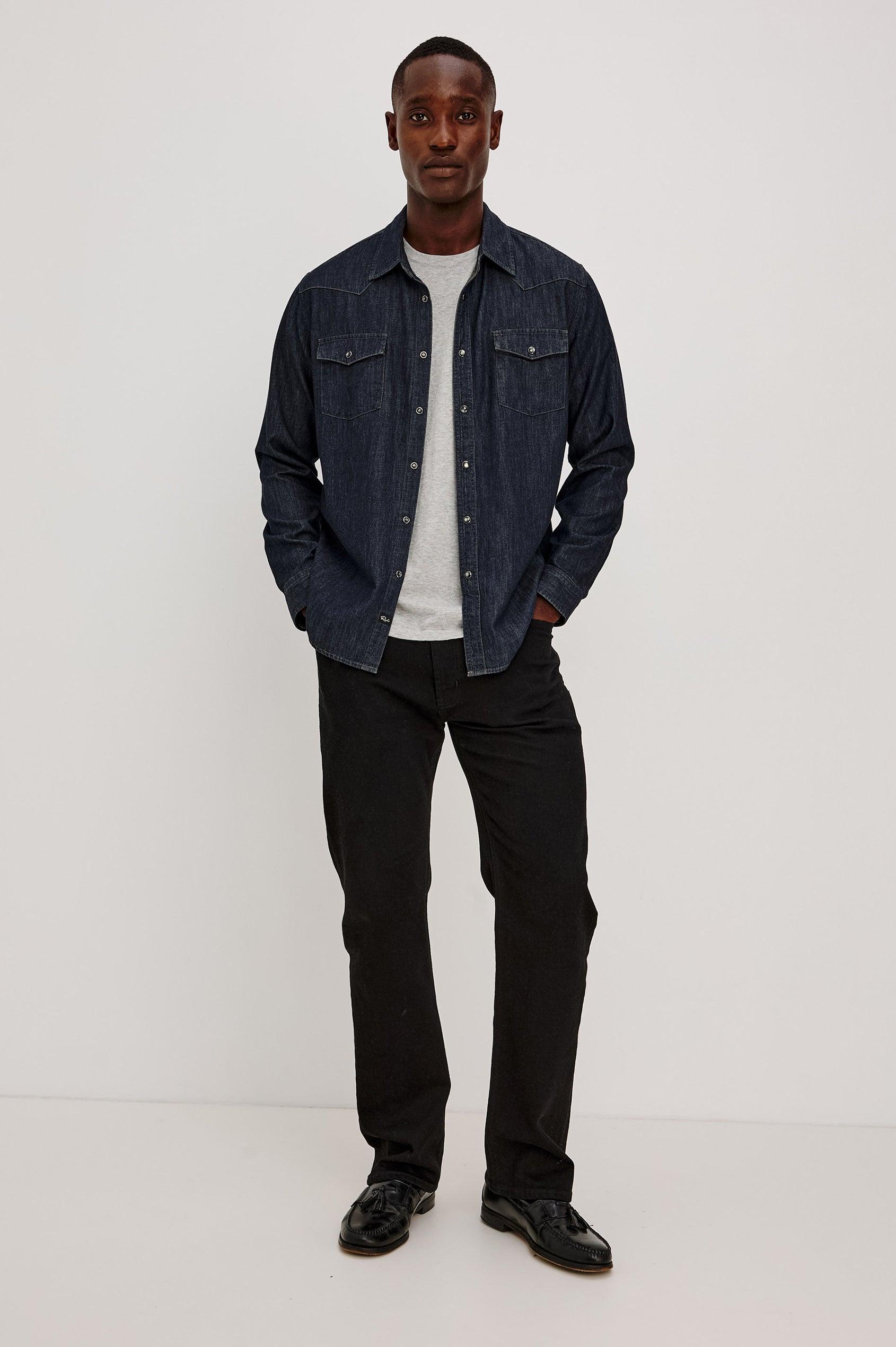 Roy Shirt in Rigid Rinsed Denim With Western Shoulder and Back Yokes, Spread Collar, Snap Front, Dual Chest Flap Pockets, and Shirttail Hem in Twilight Wash Colorway - Full Body Front View Featured on Model