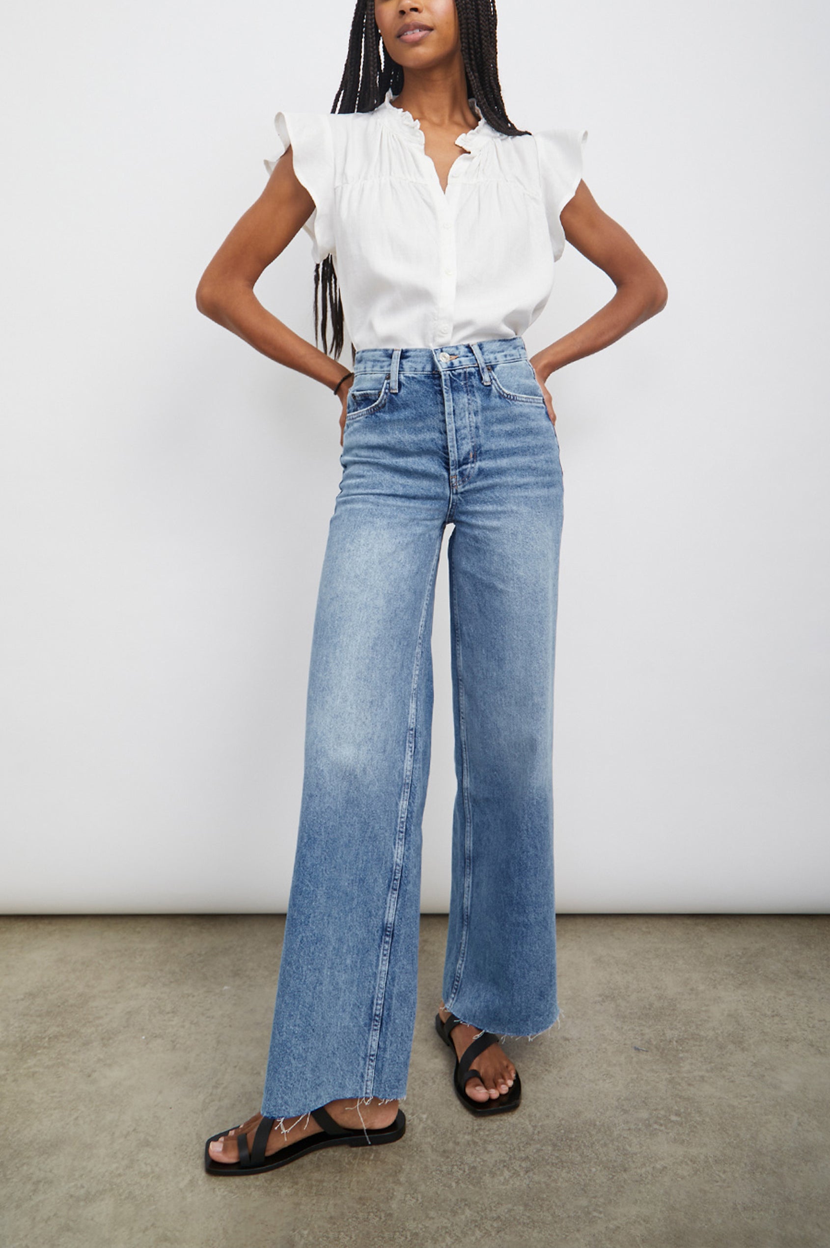 Ruthie Top with Flutter Cap Sleeves, a Ruffled Banded Collar, Buttons Down the Front, and Soft Shirring at Front Yoke in White Colorway - Front Tucked Full Body View Featured on Model
