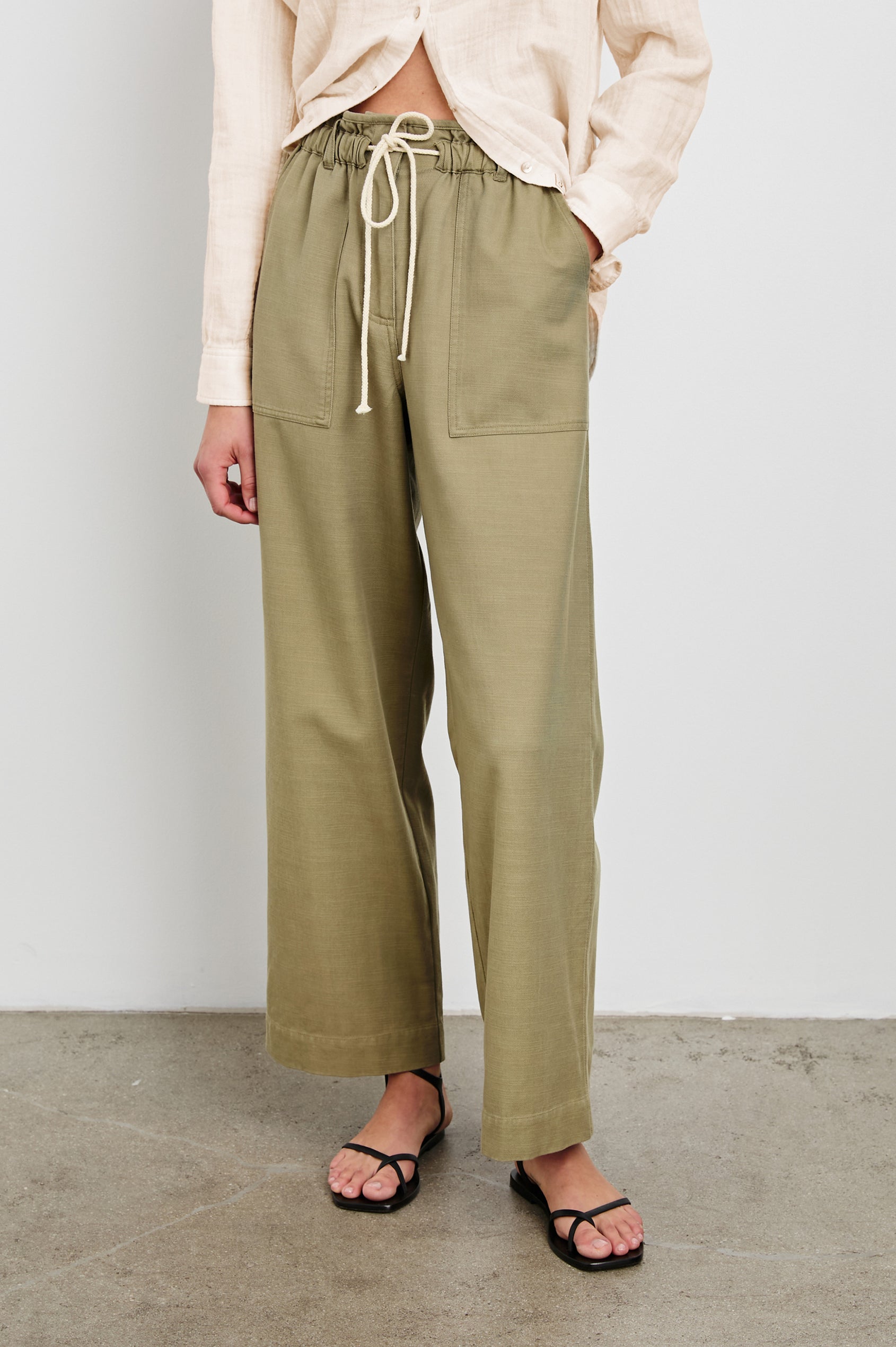 Ryan Pants with a Corded Drawstring Waist, Large Front Pockets and two Back Pockets in Pale Olive Colorway - Front View Featured on Model