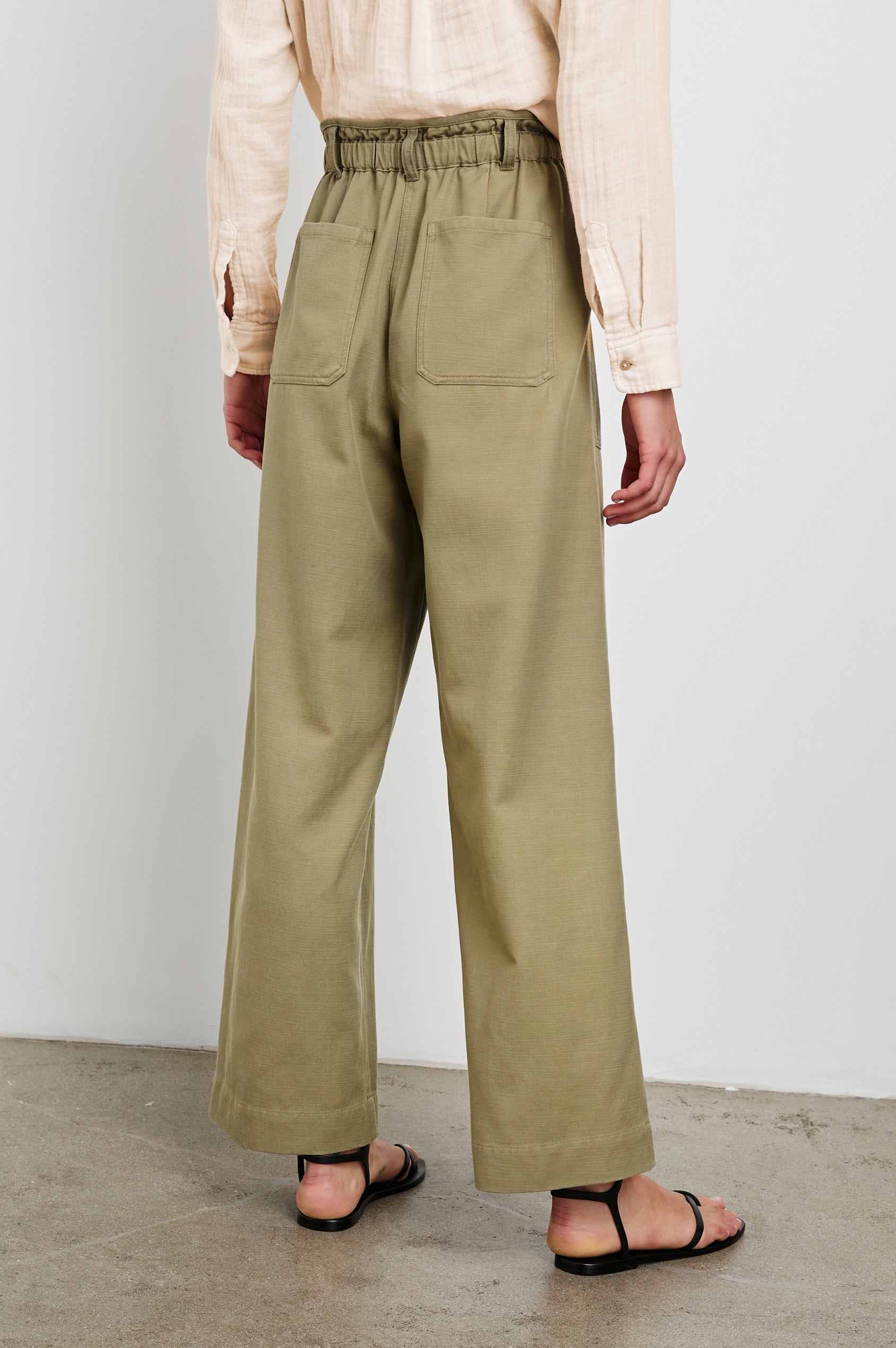 Ryan Pants with a Corded Drawstring Waist, Large Front Pockets and two Back Pockets in Pale Olive Colorway - Back View Featured on Model