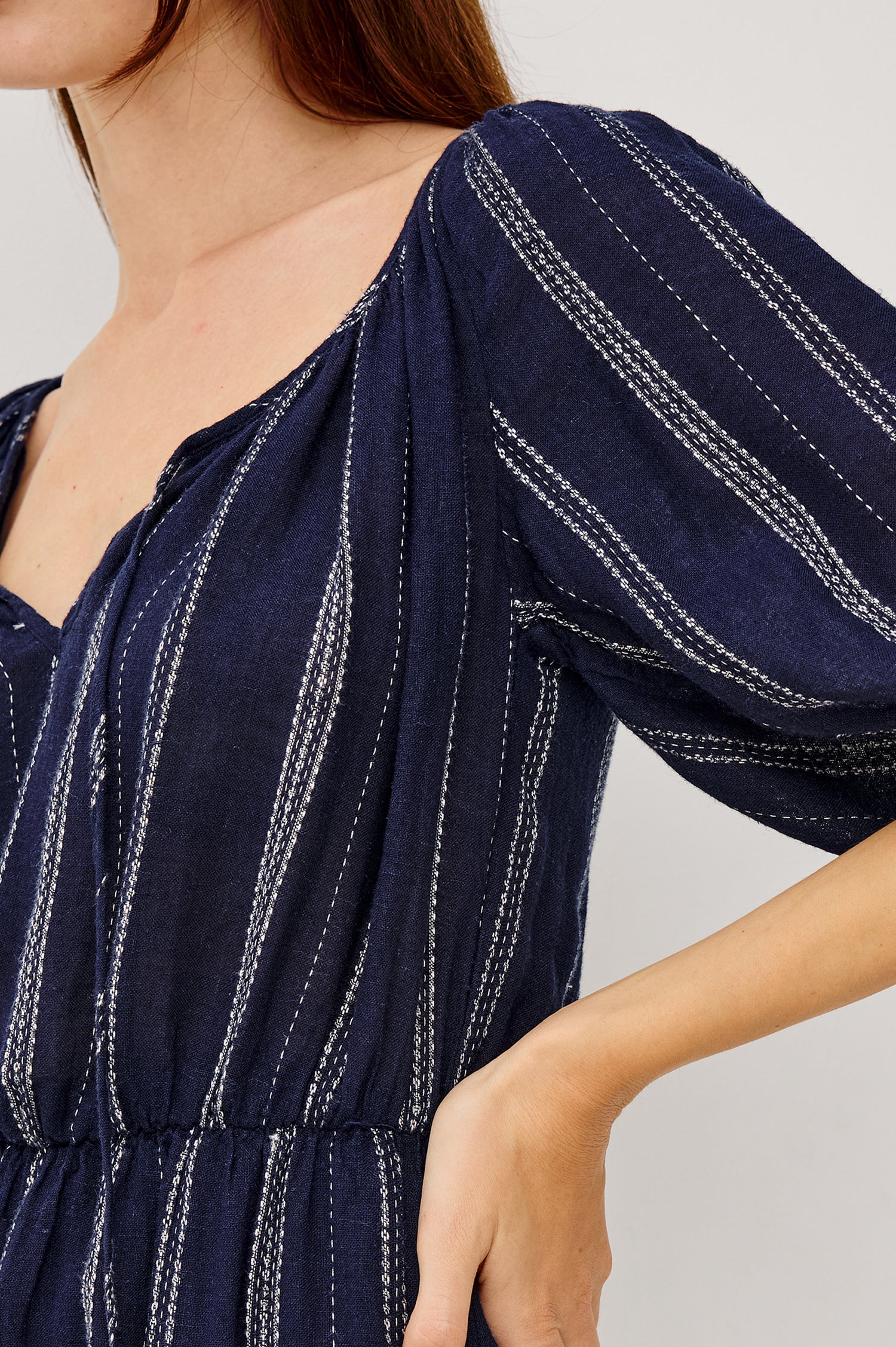 Saba Linen Mini Dress With Scoop Neckline Center-Front Ties Elbow-Length Puff Sleeves in Marina Stripe Colorway - Upper Body Side View Featured on Model