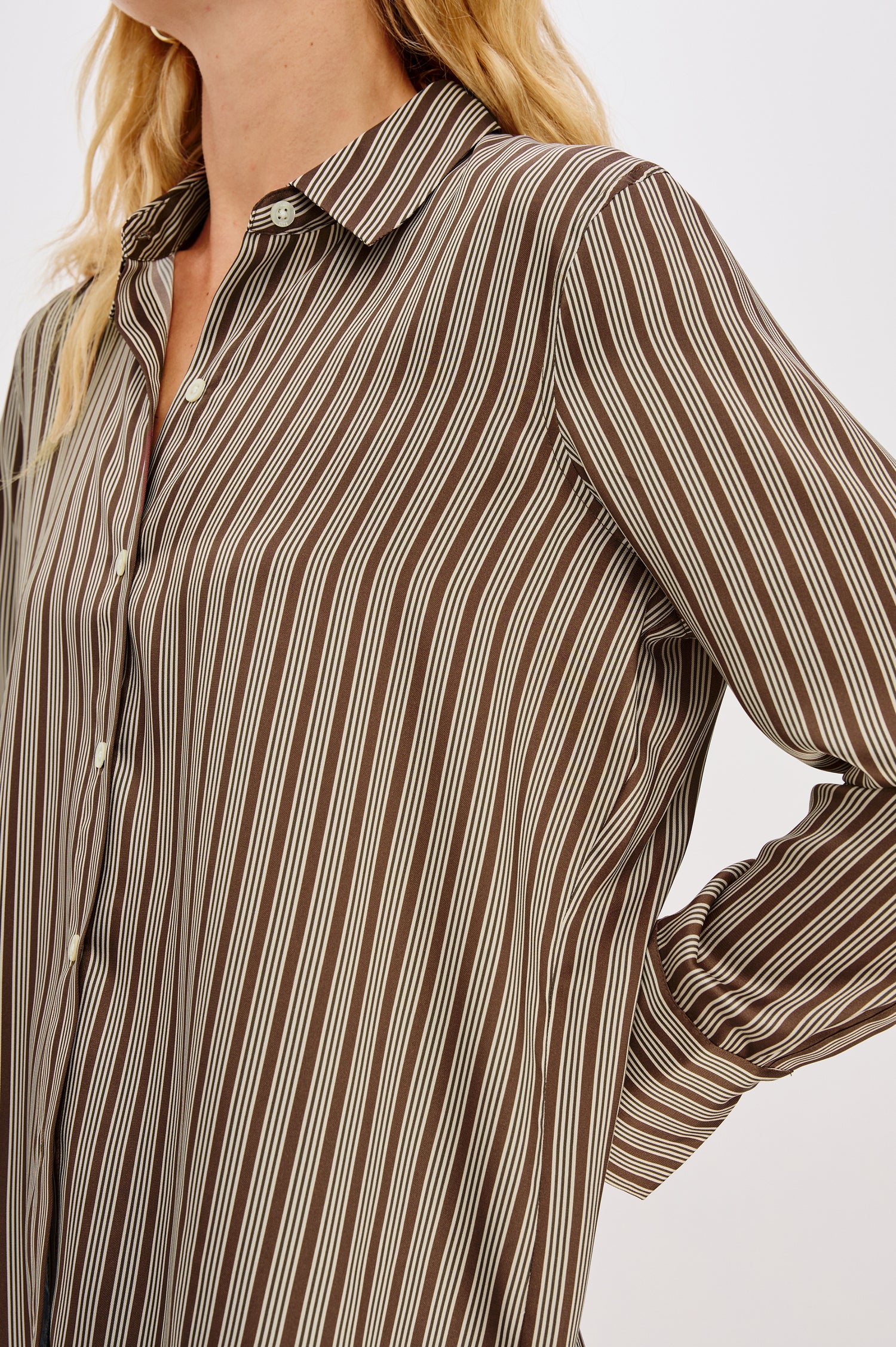 Saige Long-Sleeve Button Up in Isle Stripe colorway with brown base and thin and thick cream colored stripes  - close up of details on model