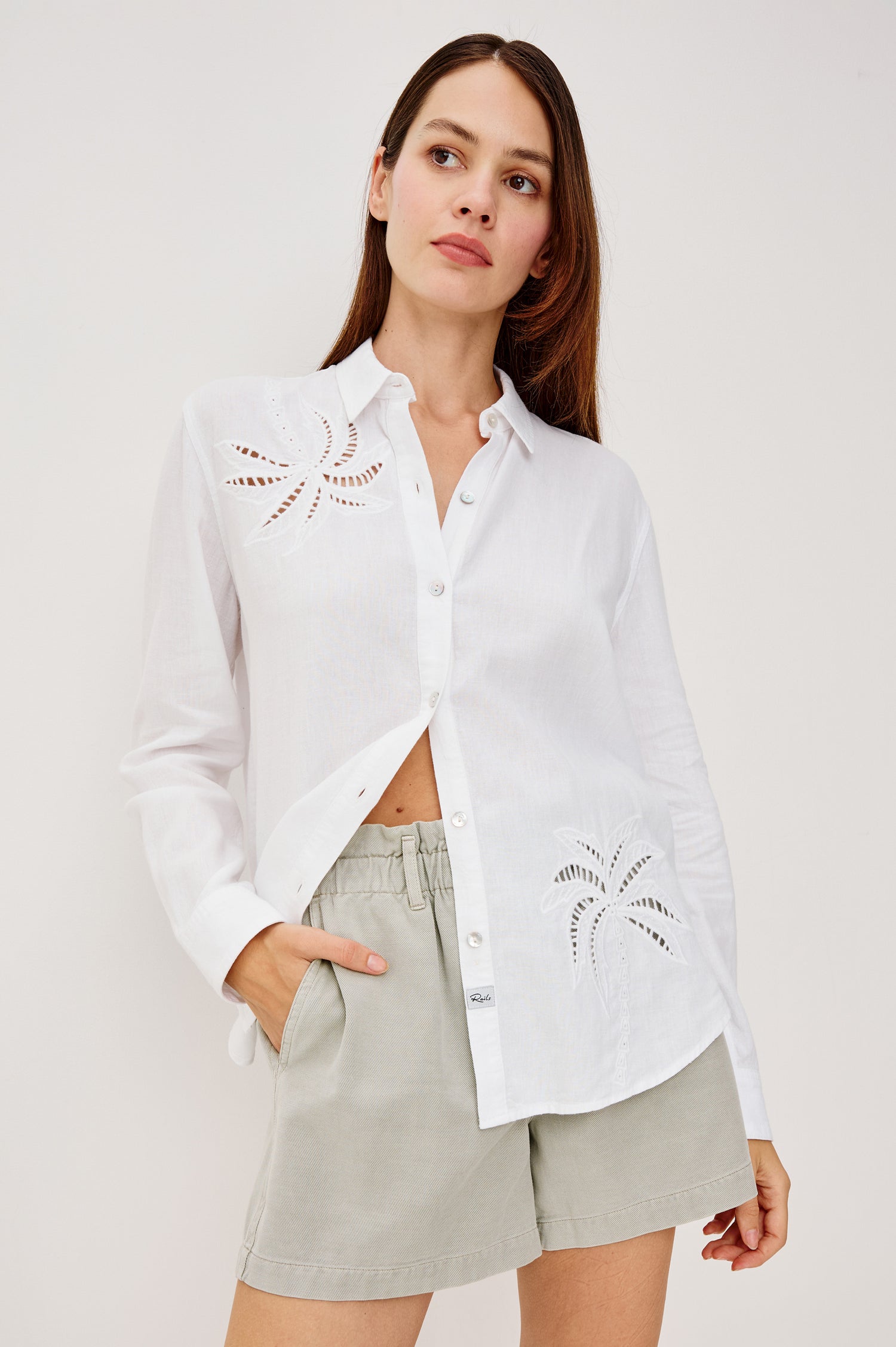 Samar Button-Up Collared Shirt in Linen With Palm Tree Eyelet Embroidery, Relaxed Fit, and Long Sleeves in White Palm Embroidery Colorway - Upper Body Front View Featured on Model
