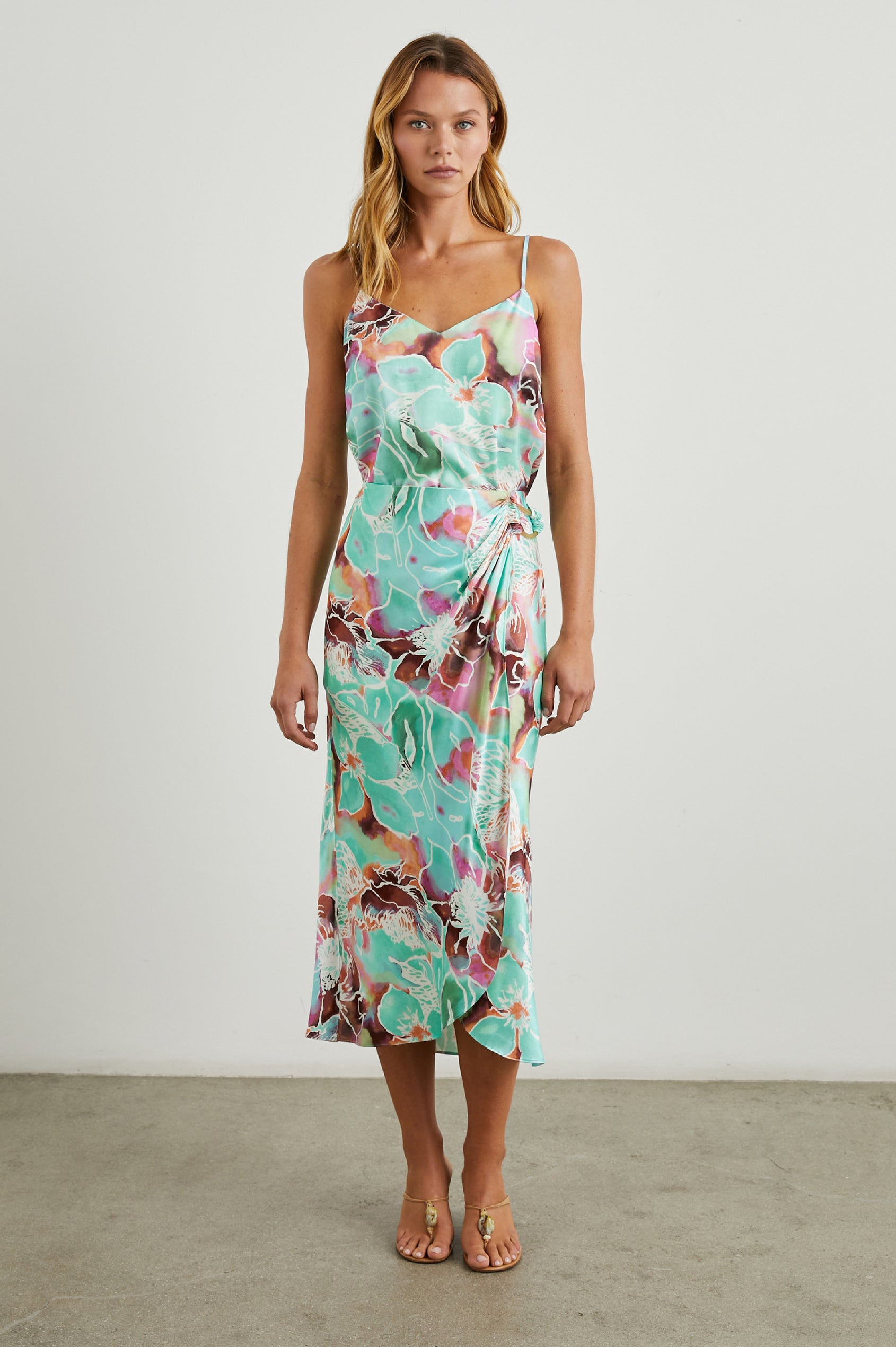 Sampha Faux Wrap Midi Skirt with a D Ring Horn Faux Closure in Kauai Floral Colorway, Flowers in Pinks, Browns, Blues, Greens and White - Front Full Body View Featured on Model 