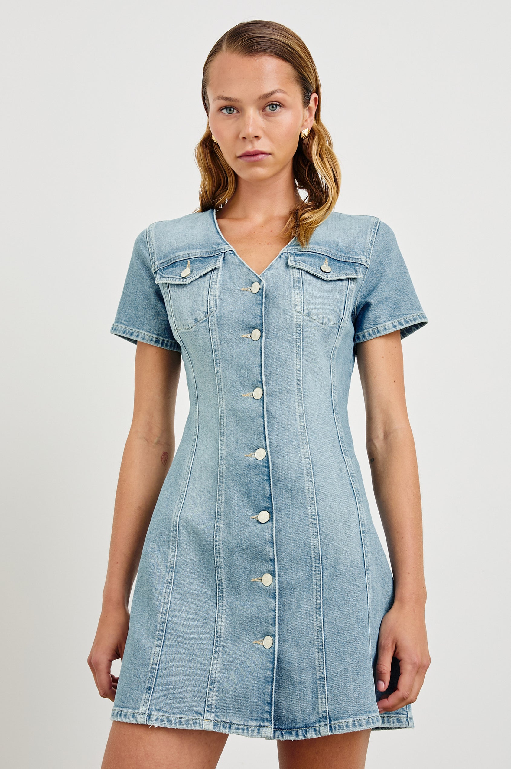 Saratoga a-line mini button down denim dress with two front chest pockets. Short sleeve and form fitting in Faded Seaglass - front view on model