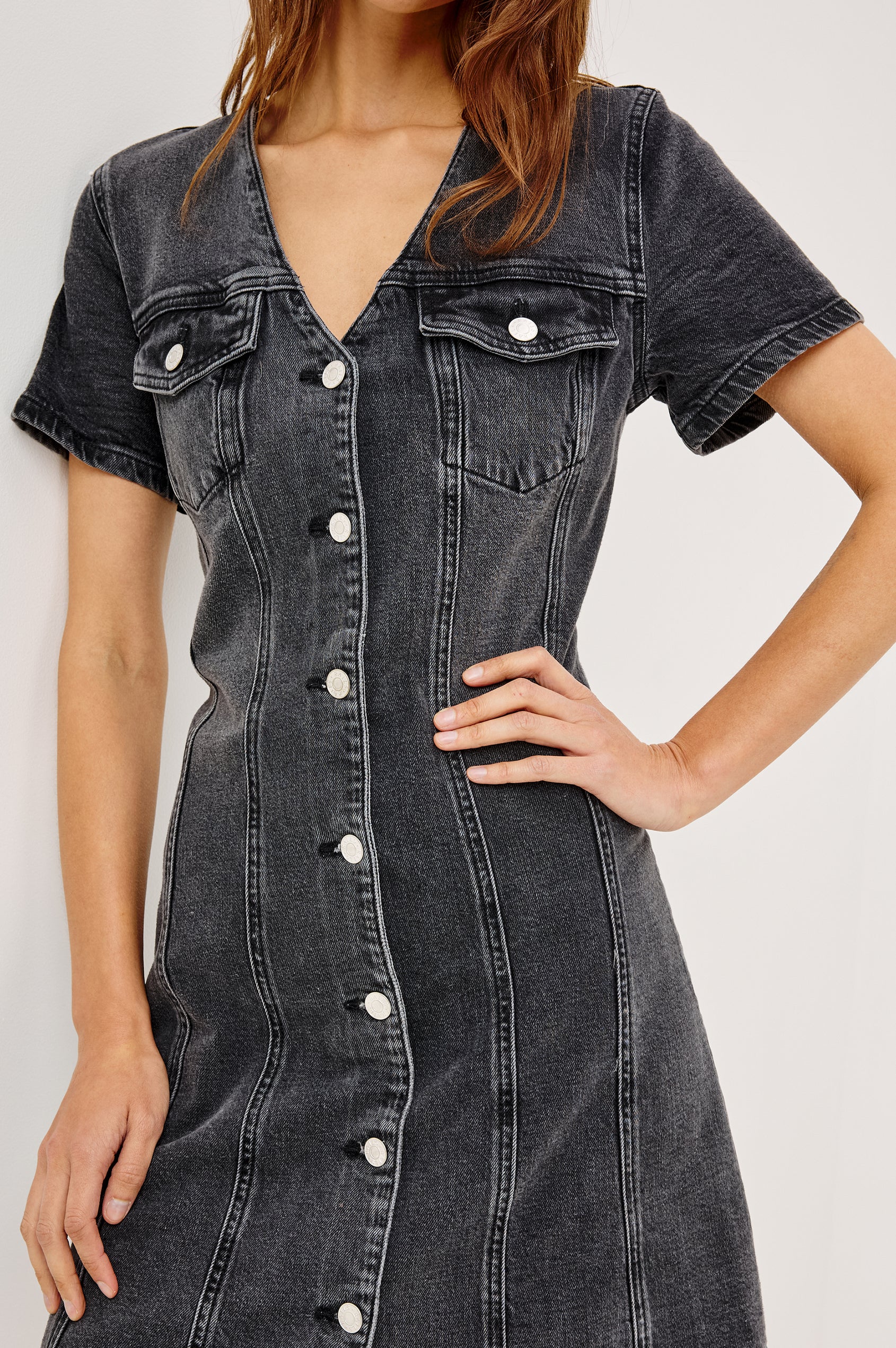 Saratoga Mini Denim Dress with a V-Neck, Short Sleeves, Button Front, Chest Flap Pockets in Washed Black Colorway. Front View Shown on Model.