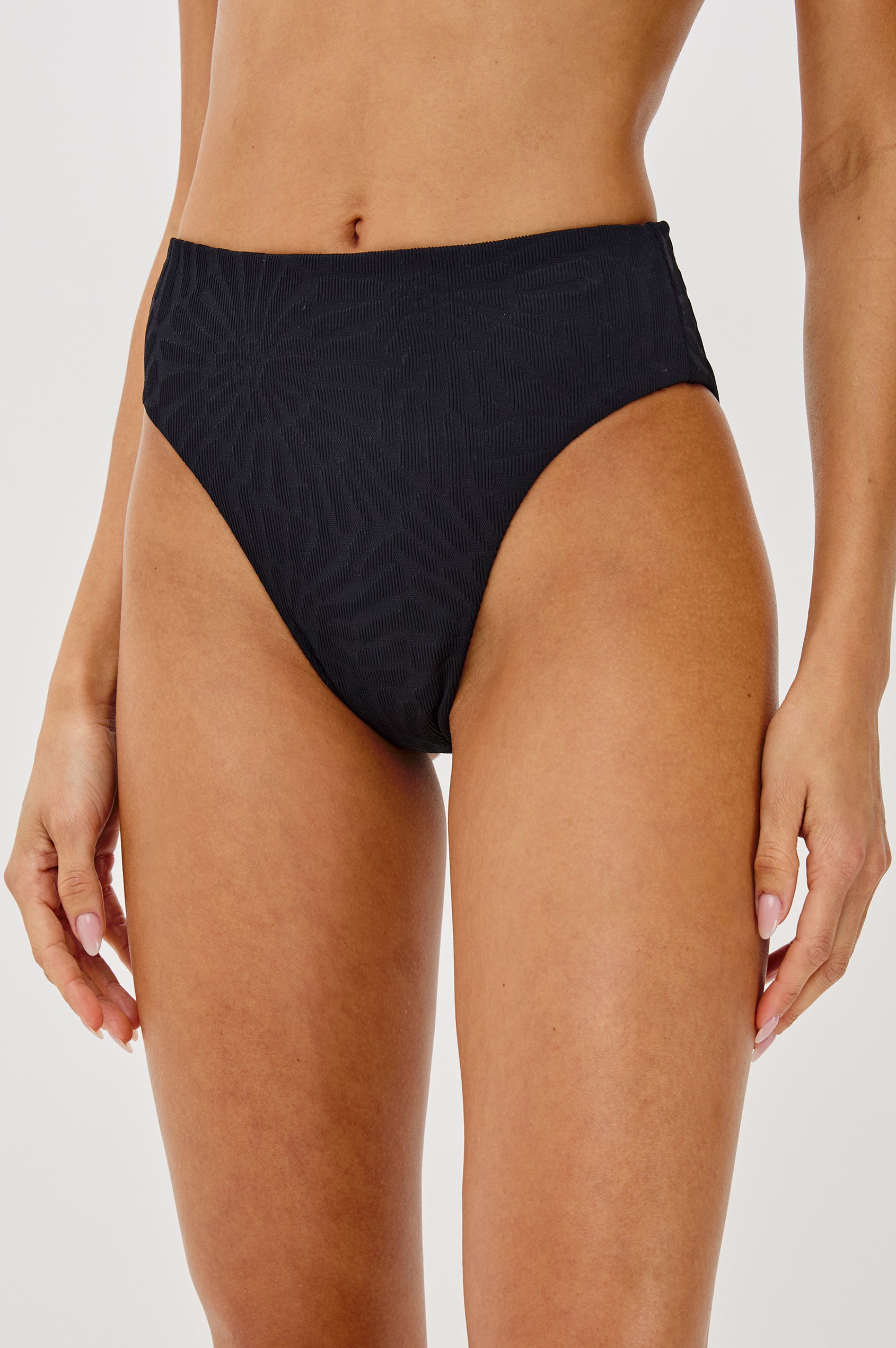 Savannah High Waist Bikini Bottom with Classic Coverage and Fossils Texture in Black Colorway. Front Detailed View Shown on Model.