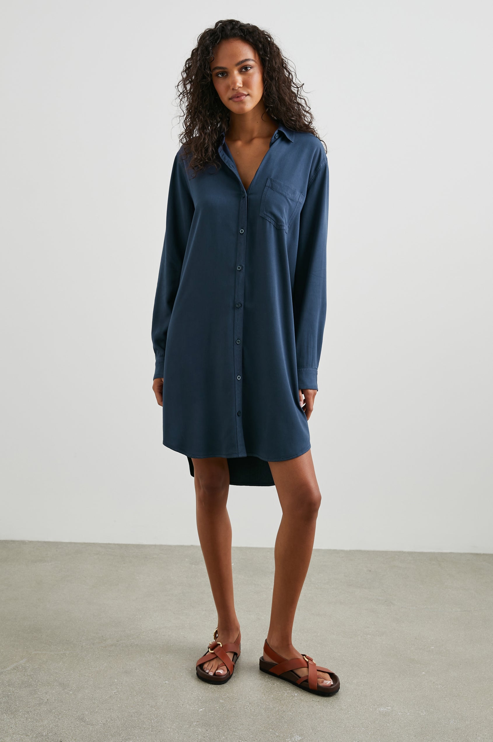 Sawyer Long-Sleeve Mini Dress with a Full Button Front, a Chest Patch Pocket, a Collar, Button Cuffs and a Low High Hem in Navy Colorway - Front Full Body View Featured on Model 