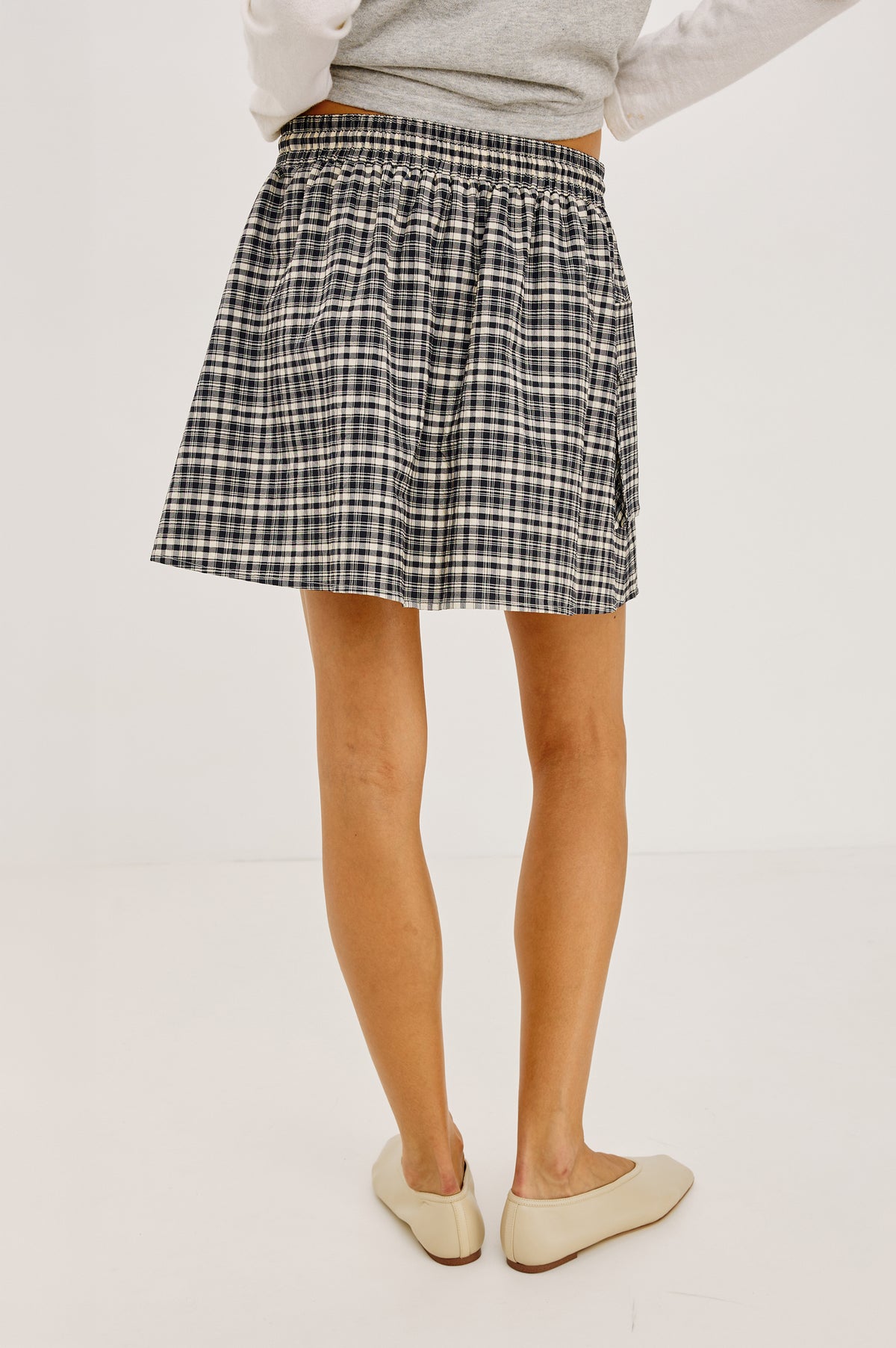 Sayana Mini Skirt in Crinkle Nylon With High-Waisted Fit, Elastic Drawcord Waist, Side Flap Pocket, and Full Lining in Mini Check Colorway - Lower Body Back View Featured on Model