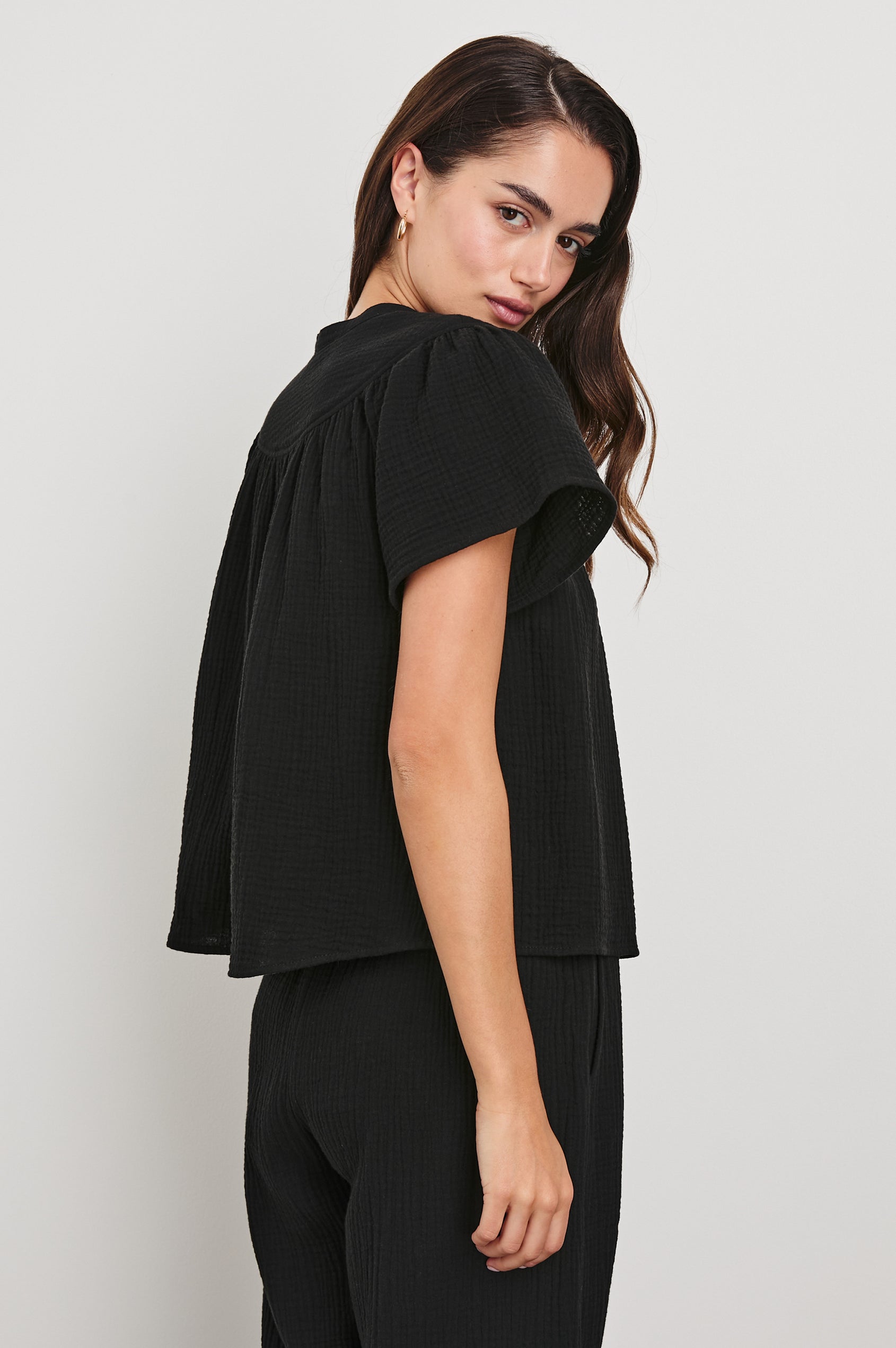 Sayer Short Sleeve Cotton Gauze Top With V-Neck In Colorway Black - Side View Featured On Model 