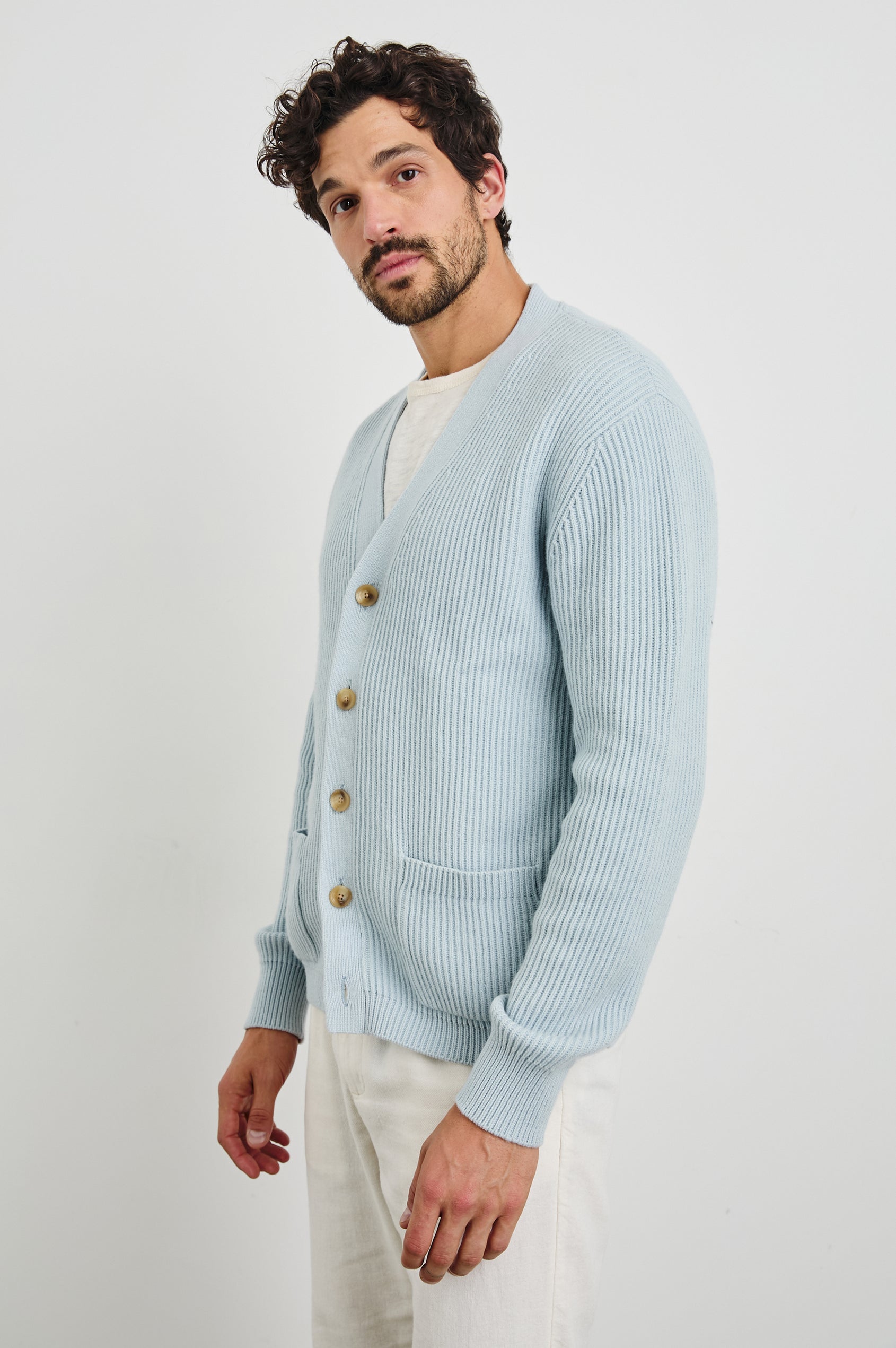 Sean Long-Sleeve Ribbed Sweater with V neck, Button Closure and Two Front Patch Pockets in Skyway Colorway - Side View Featured on Model