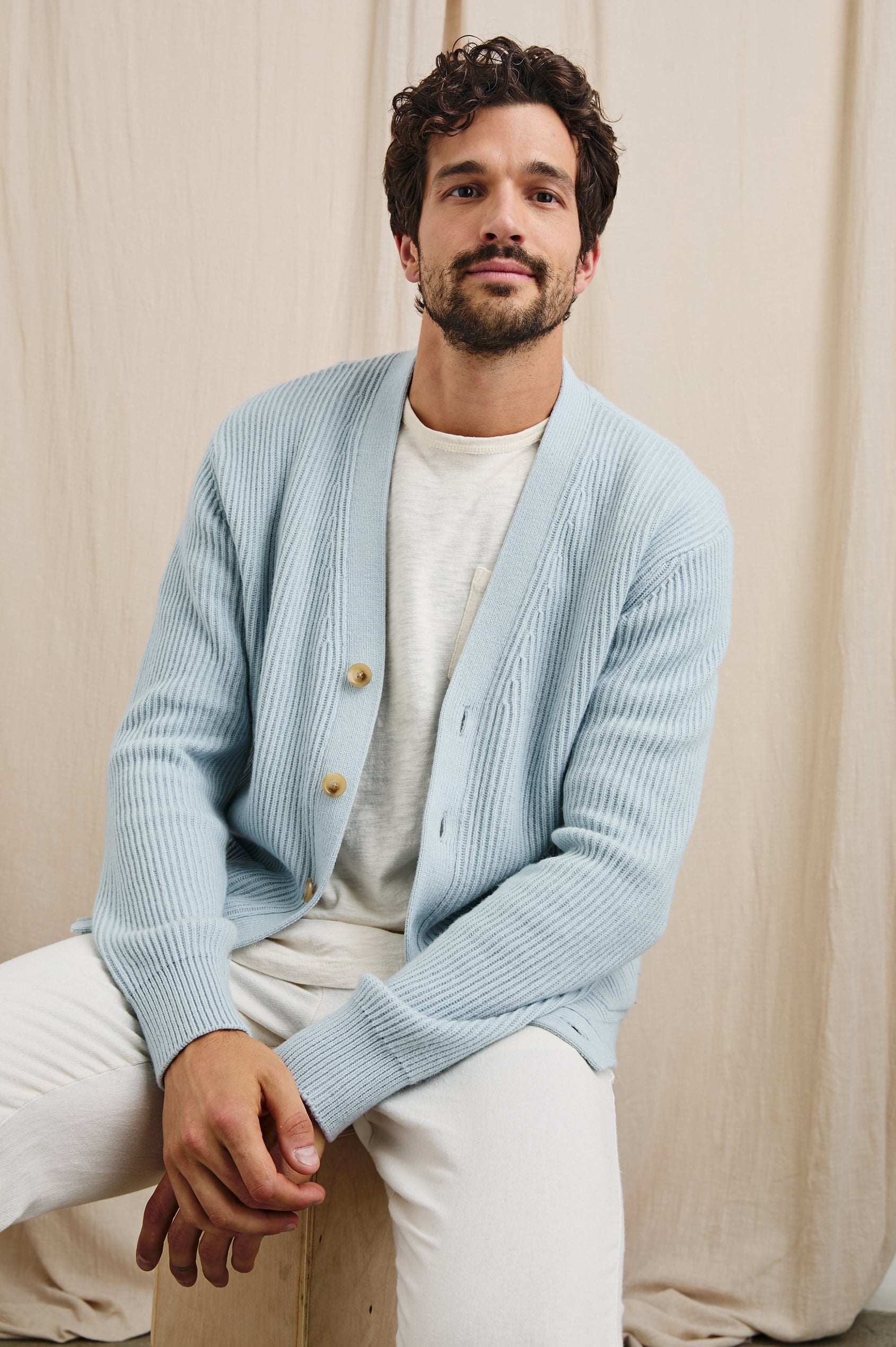 Sean Long-Sleeve Ribbed Sweater with V neck, Button Closure and Two Front Patch Pockets in Skyway Colorway - Front Unbuttoned View Featured on Seated Model