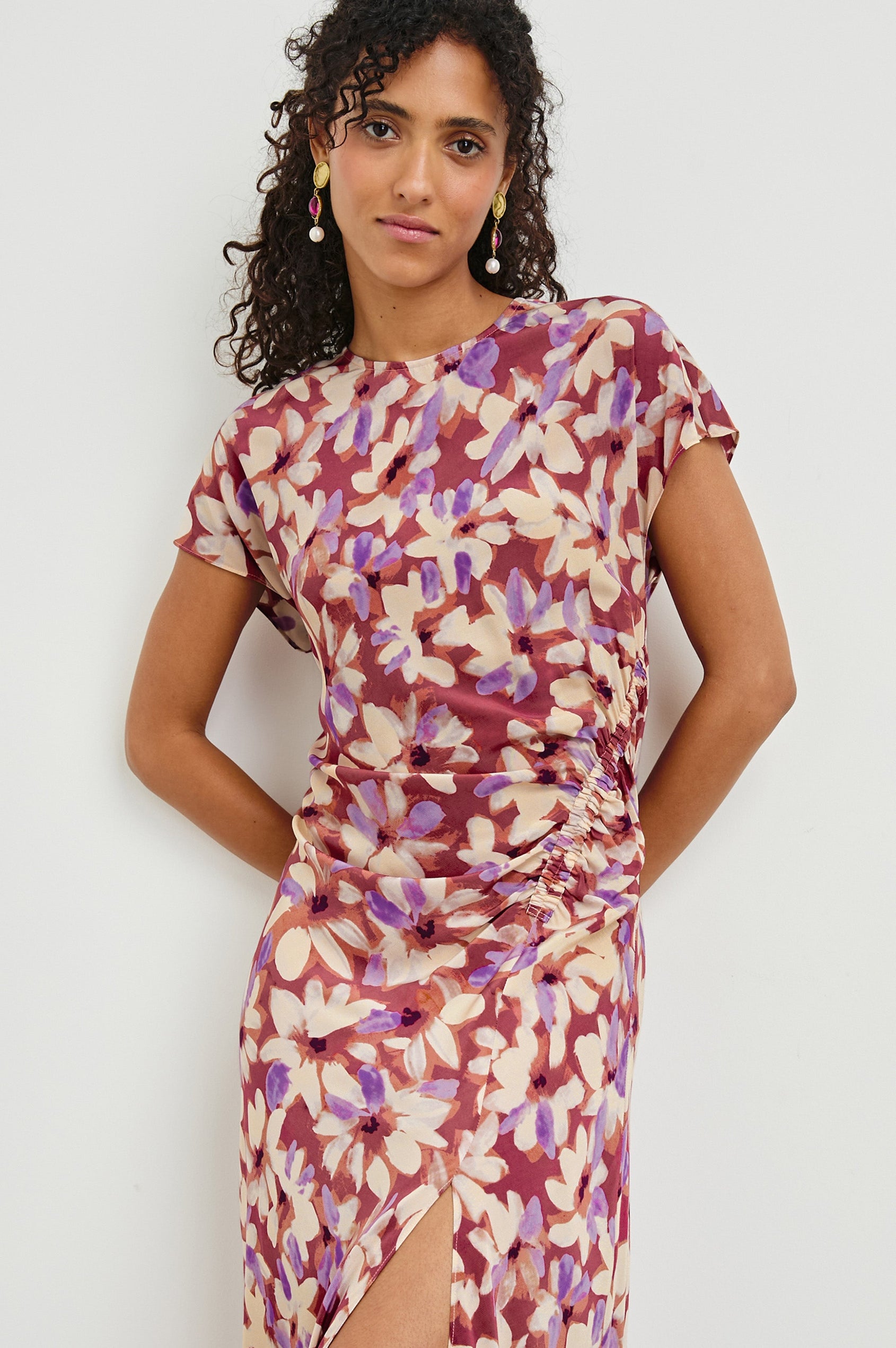 Serenity midi length crew neck dress with short sleeves, asymmetrical draping and side slit in Amaranth print - close up of details on model