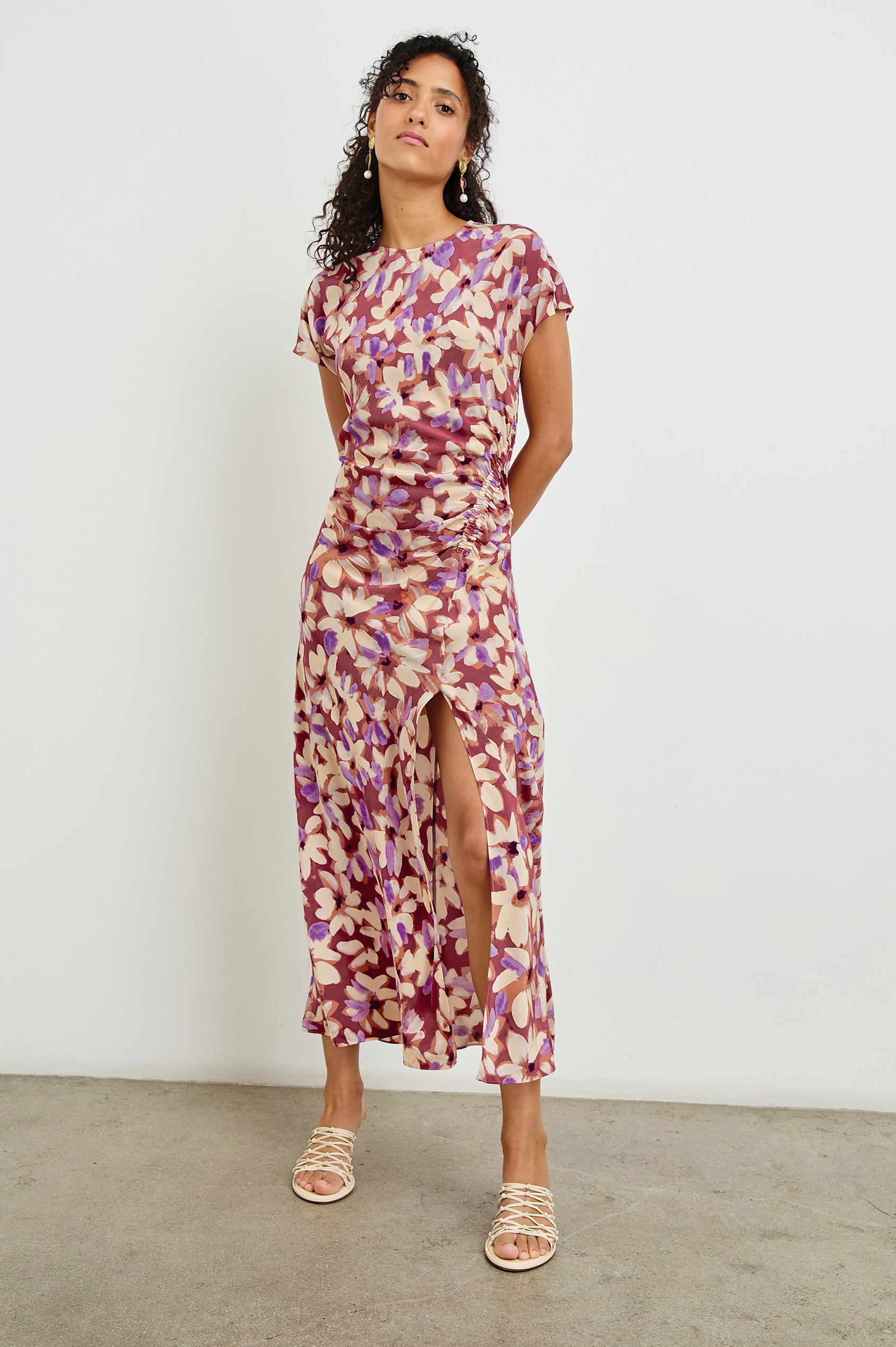 Serenity midi length crew neck dress with short sleeves, asymmetrical draping and side slit in Amaranth print - full body front view on model