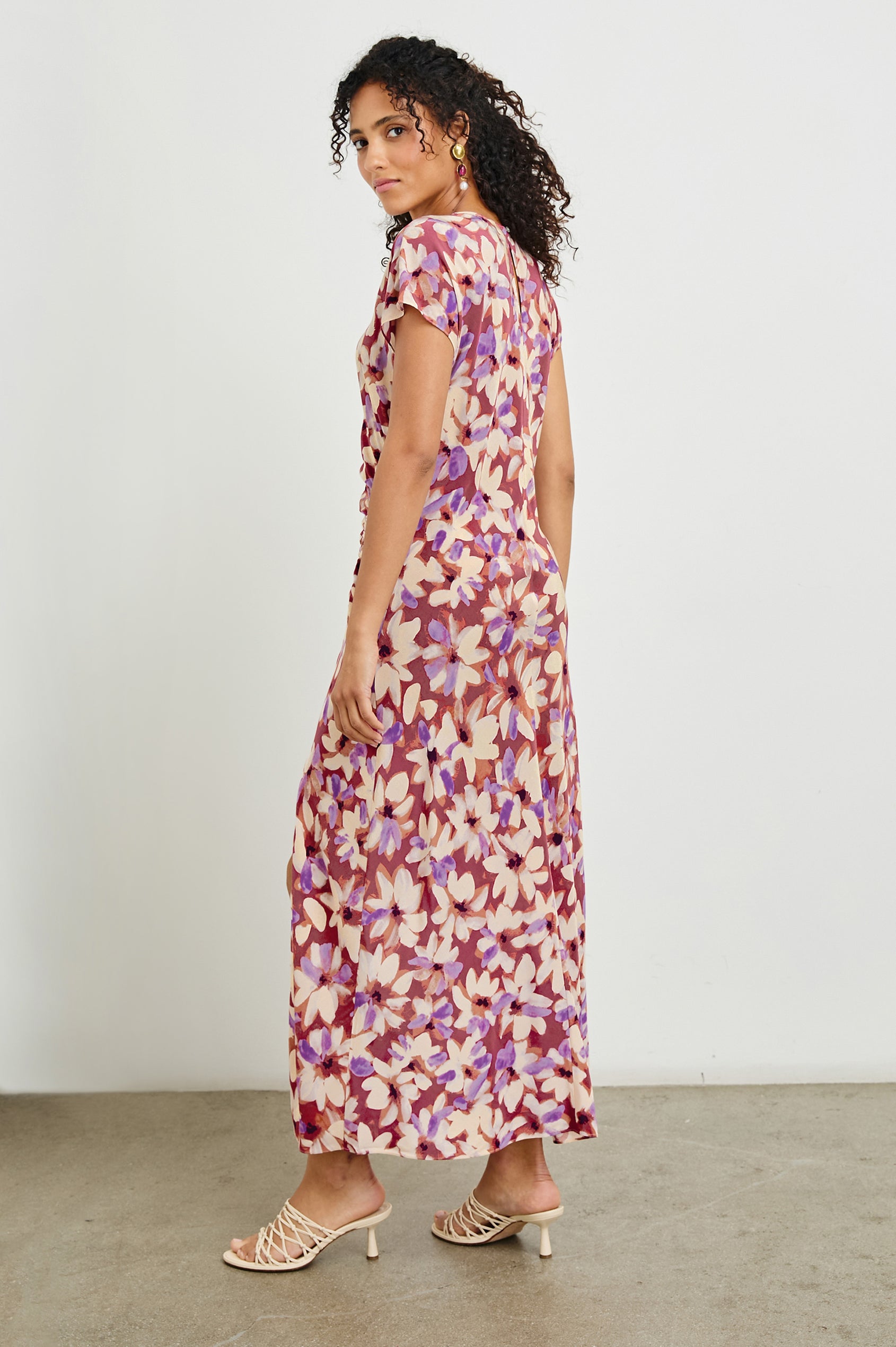 Serenity midi length crew neck dress with short sleeves, asymmetrical draping and side slit in Amaranth print - back view on model