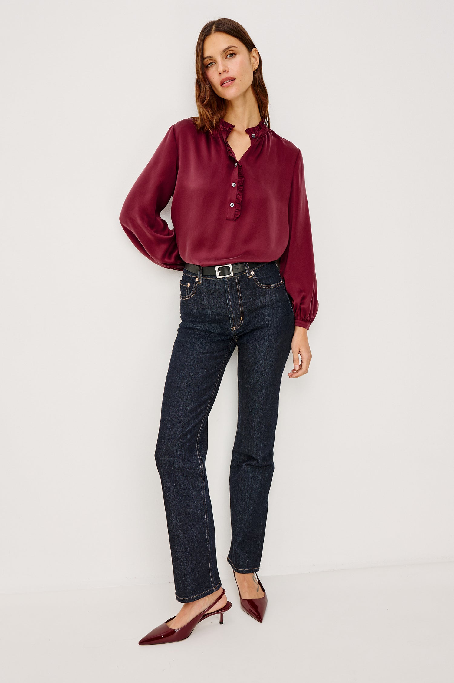 Sien Top in Silk Charmeuse With Ruffled High Neckline, Half Button Placket, and Long Billowing Sleeves With Fitted Cuffs in Garnet Colorway - Full Body Front View Featured on Model