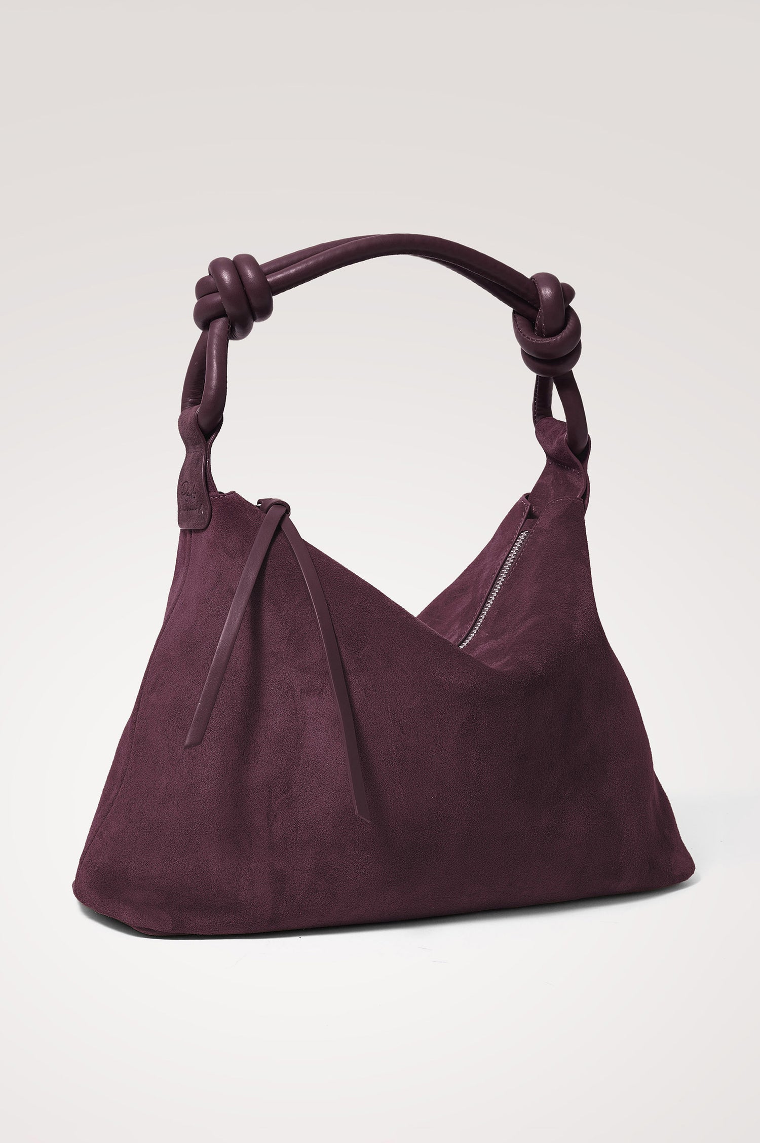 Siena Hobo Bag in Suede With Knotted Top Strap, Zip Closure With Fringe Tassel Pull, Microsuede Lining, Snap-Button Slip Pocket and Foil Logo Stamp at Interior in Plum Suede Colorway -