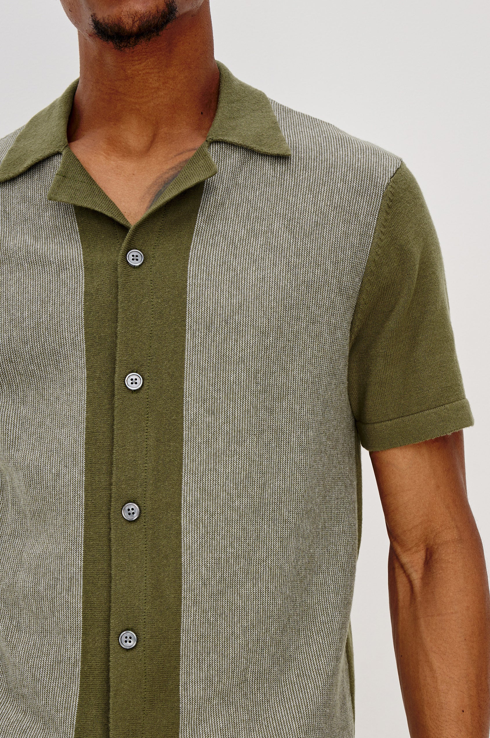 Silas short sleeve knit button down shirt with retro front striped design features in Olive Khaki Stripe - front detail view on model