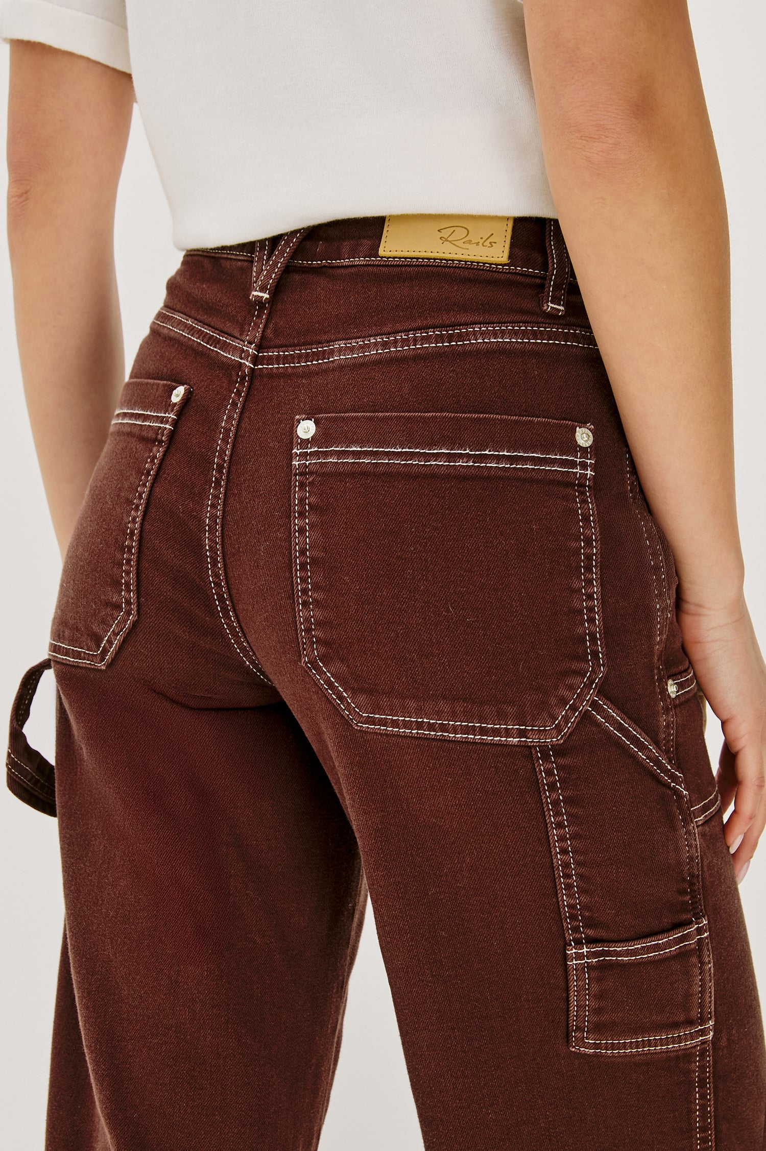 Silverado high rise wide leg crop pant with carpenter style details and contrast stitching in Chocolate Contrast Stitch - back detail view on model.