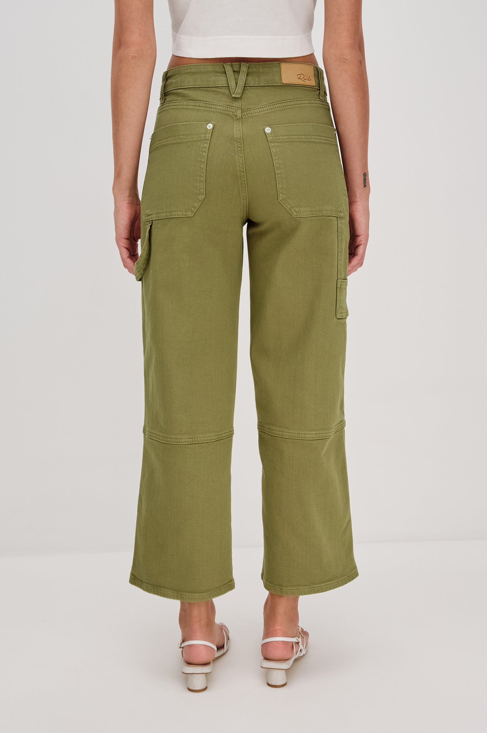 Silverado high rise wide leg crop pant with carpenter style details and contrast stitching in Dark Olive - back view on model