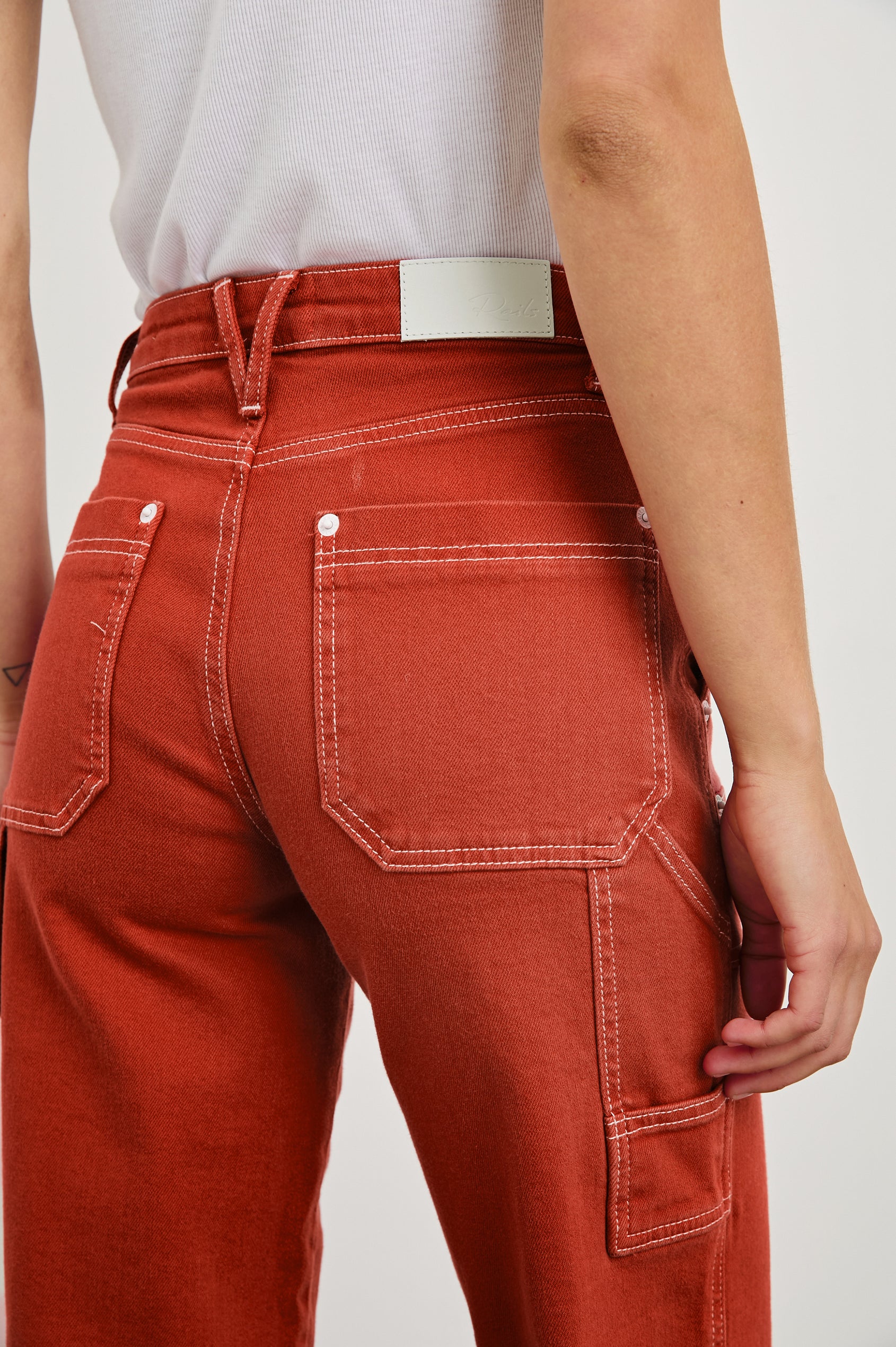 Silverado high rise wide leg crop pant with carpenter style details and contrast stitching in Terracotta - close up of back details on model