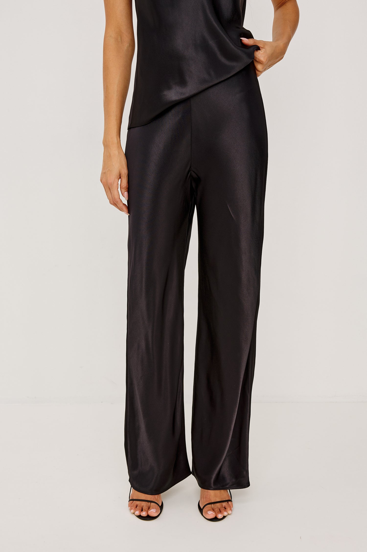 Silvi High-Waisted Pant in Metallic Satin Back Crepe With Elastic Waistband and Straight Legs in Black Colorway - Lower Body Front View Featured on Model