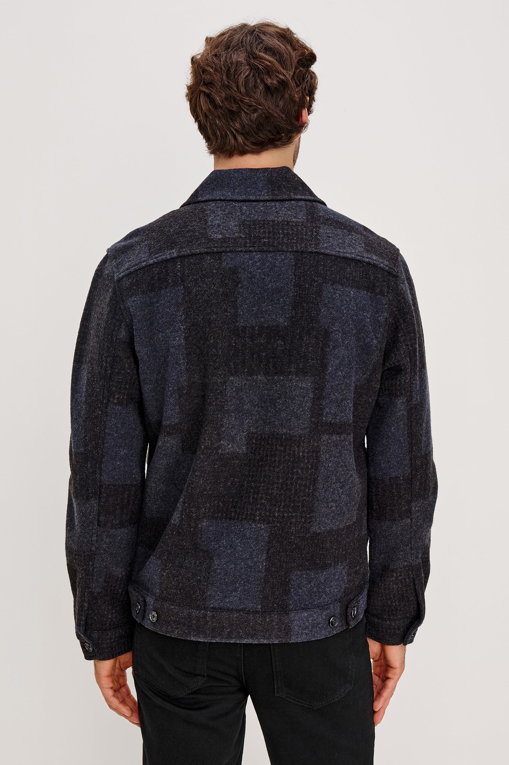 The Simon is a collared zip front jacket with front patch pockets in Black Navy Block colorway. Back view featured on model.