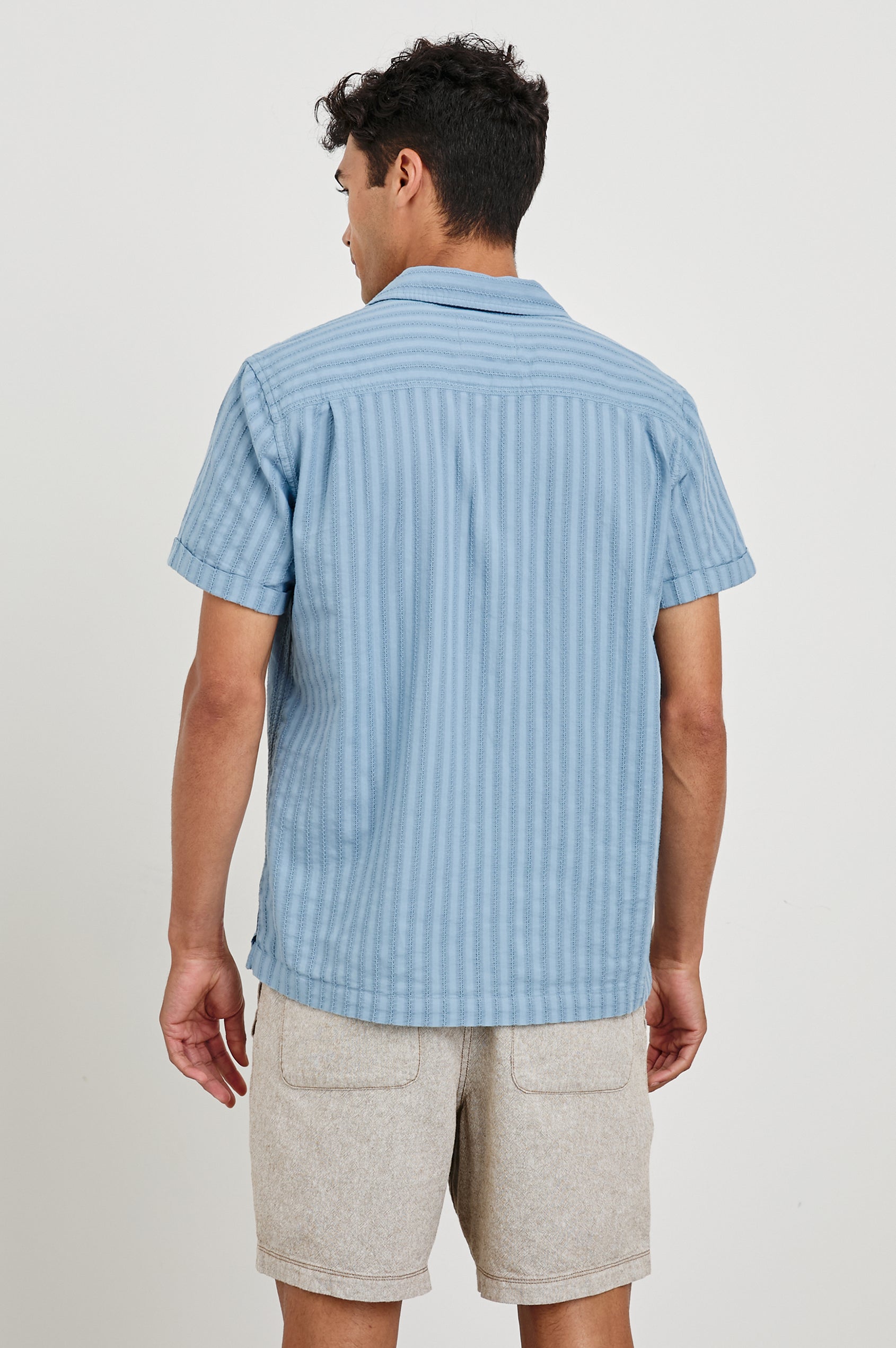 Sinclair short sleeve button up shirt with camp collar in Faded Blue with stripes - back view on model