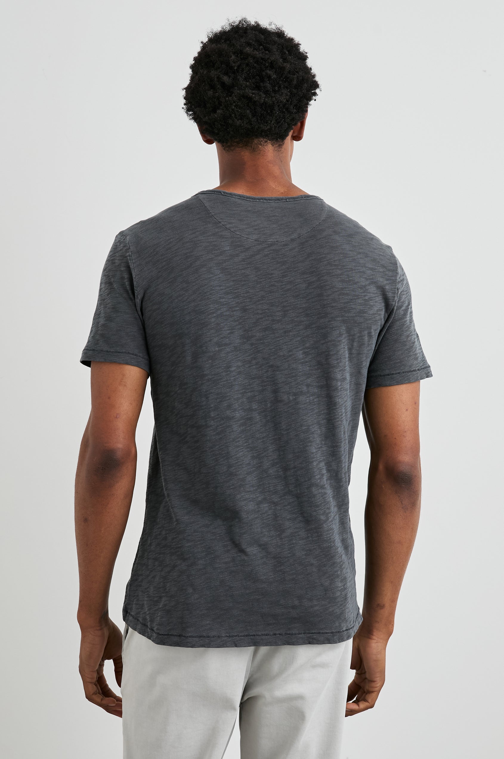 Skipper Short-Sleeve T-shirt with a Crew Neck and a Chest Patch Pocket in Faded Navy Colorway - Back View Featured on Model
