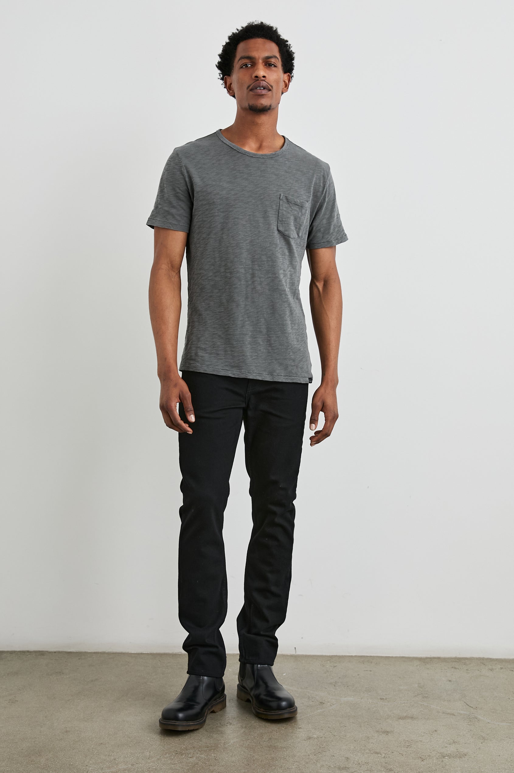 Skipper Short-Sleeve T-shirt with a Crew Neck and a Chest Patch Pocket in Washed Black Colorway - Front Full Body View Featured on Model