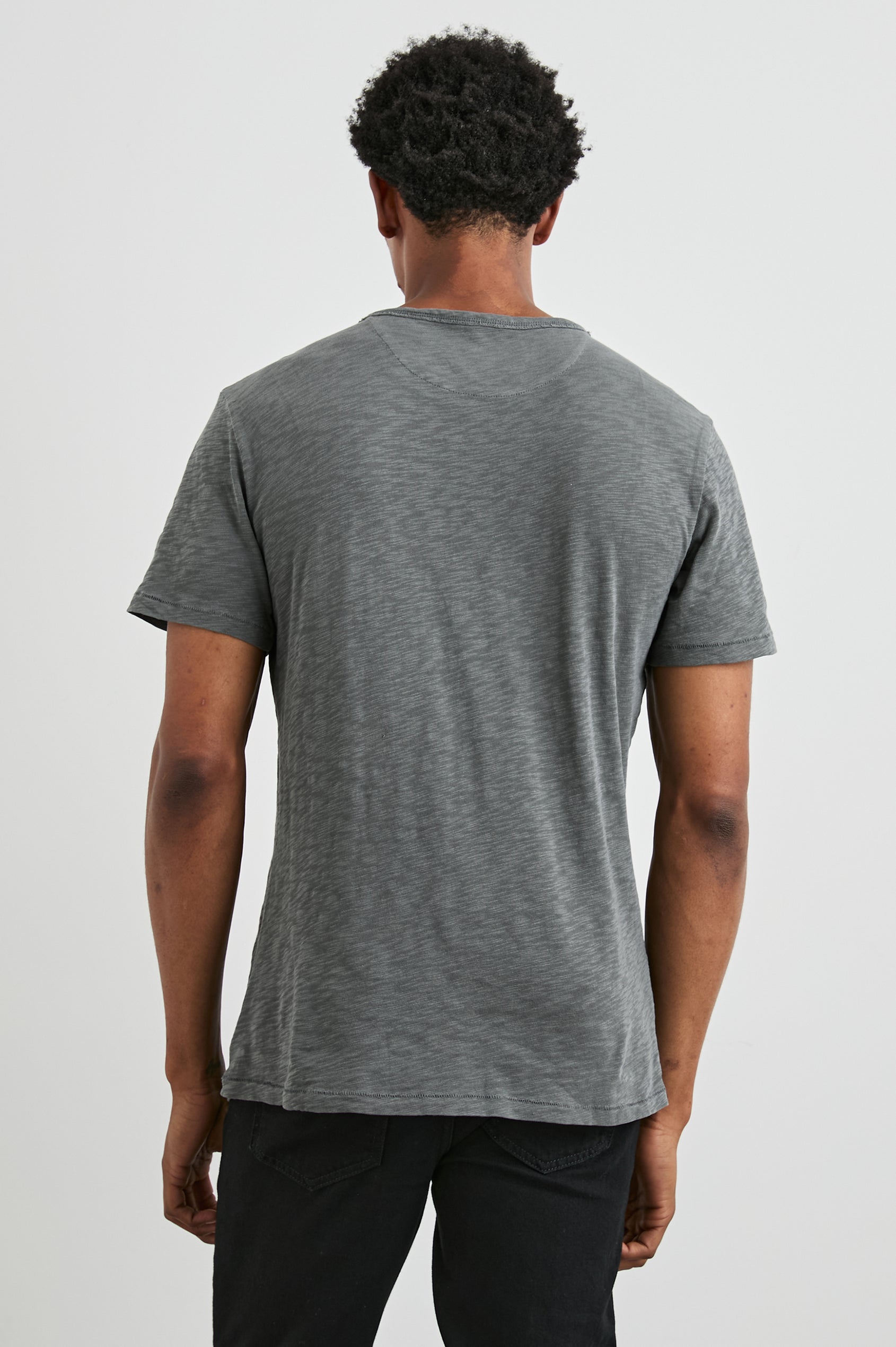 Skipper Short-Sleeve T-shirt with a Crew Neck and a Chest Patch Pocket in Washed Black Colorway - Back View Featured on Model