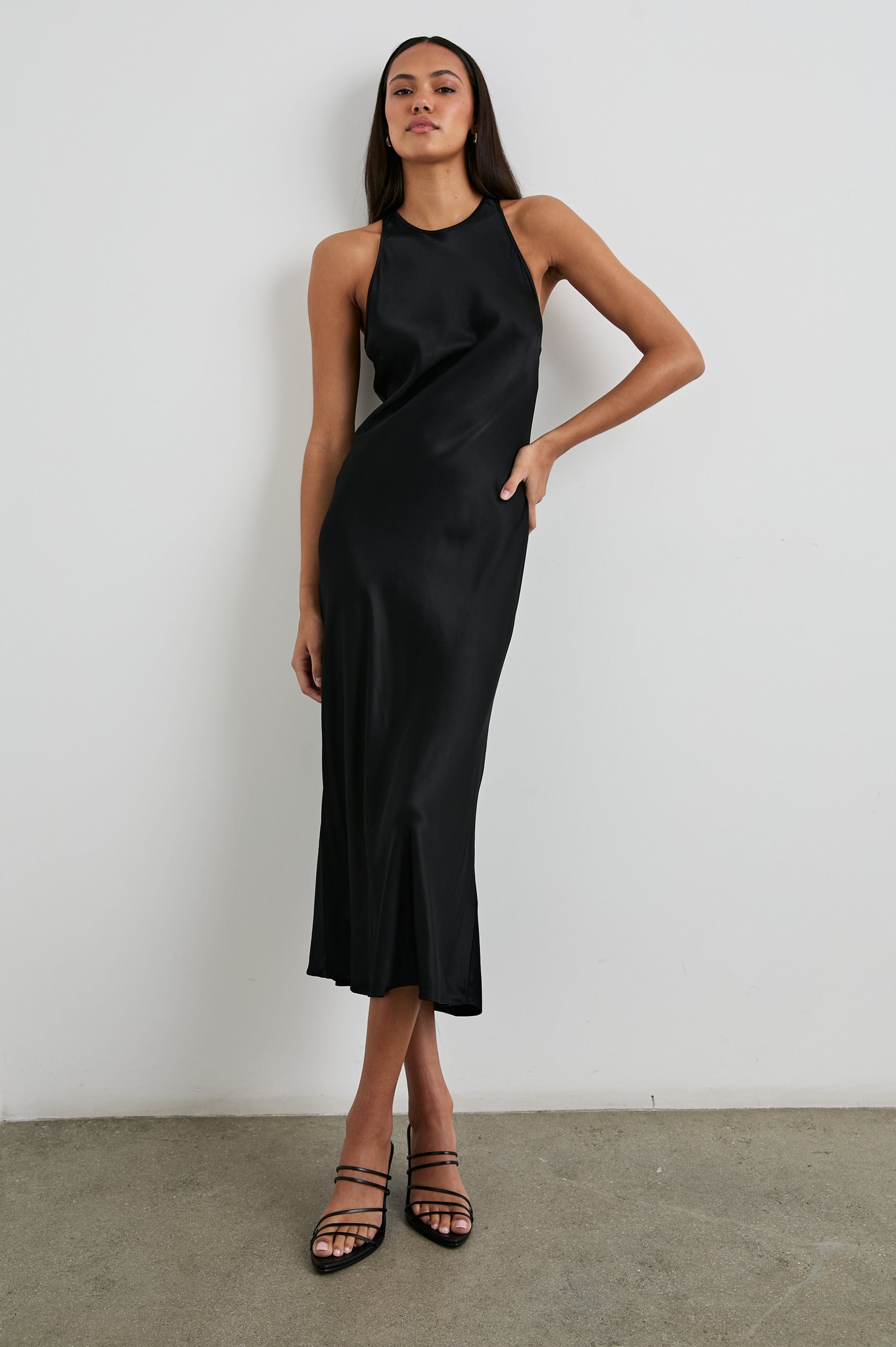 Solene Sleeveless Midi Dress with a Crew Neck and a Tie Keyhole at the Back in Black Colorway - Front Full Body View Featured on Model