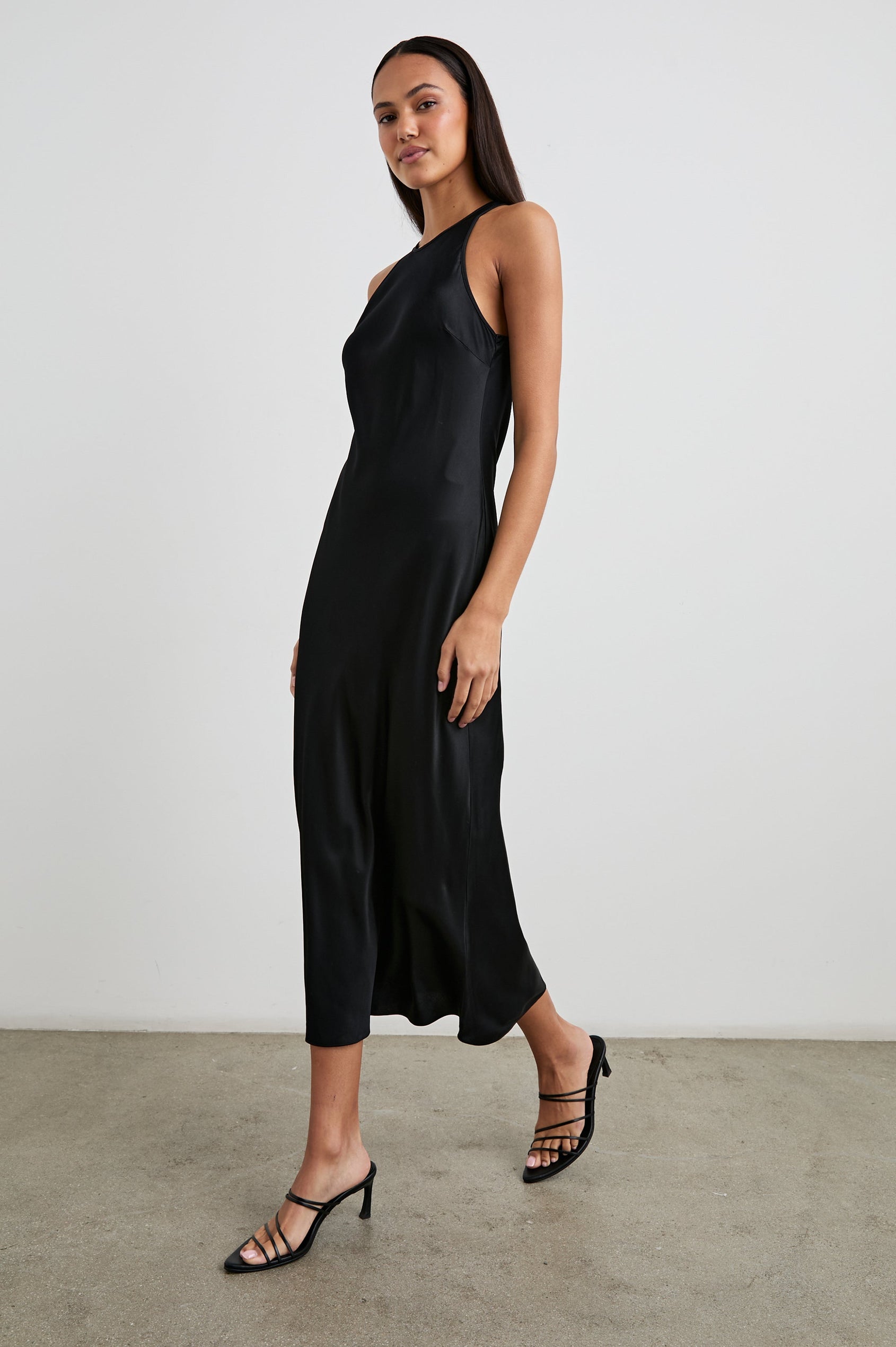 Solene Sleeveless Midi Dress with a Crew Neck and a Tie Keyhole at the Back in Black Colorway - Front Full Body View Featured on Model
